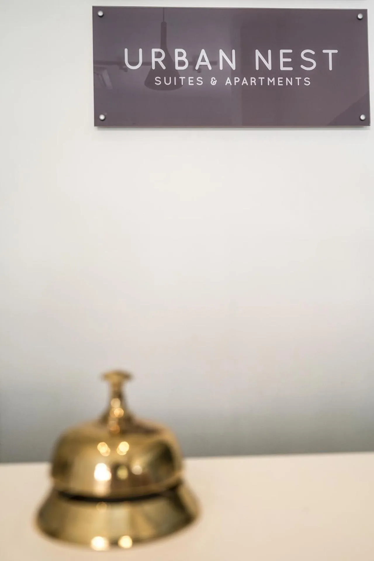 Property logo or sign in Urban Nest - Suites & Apartments