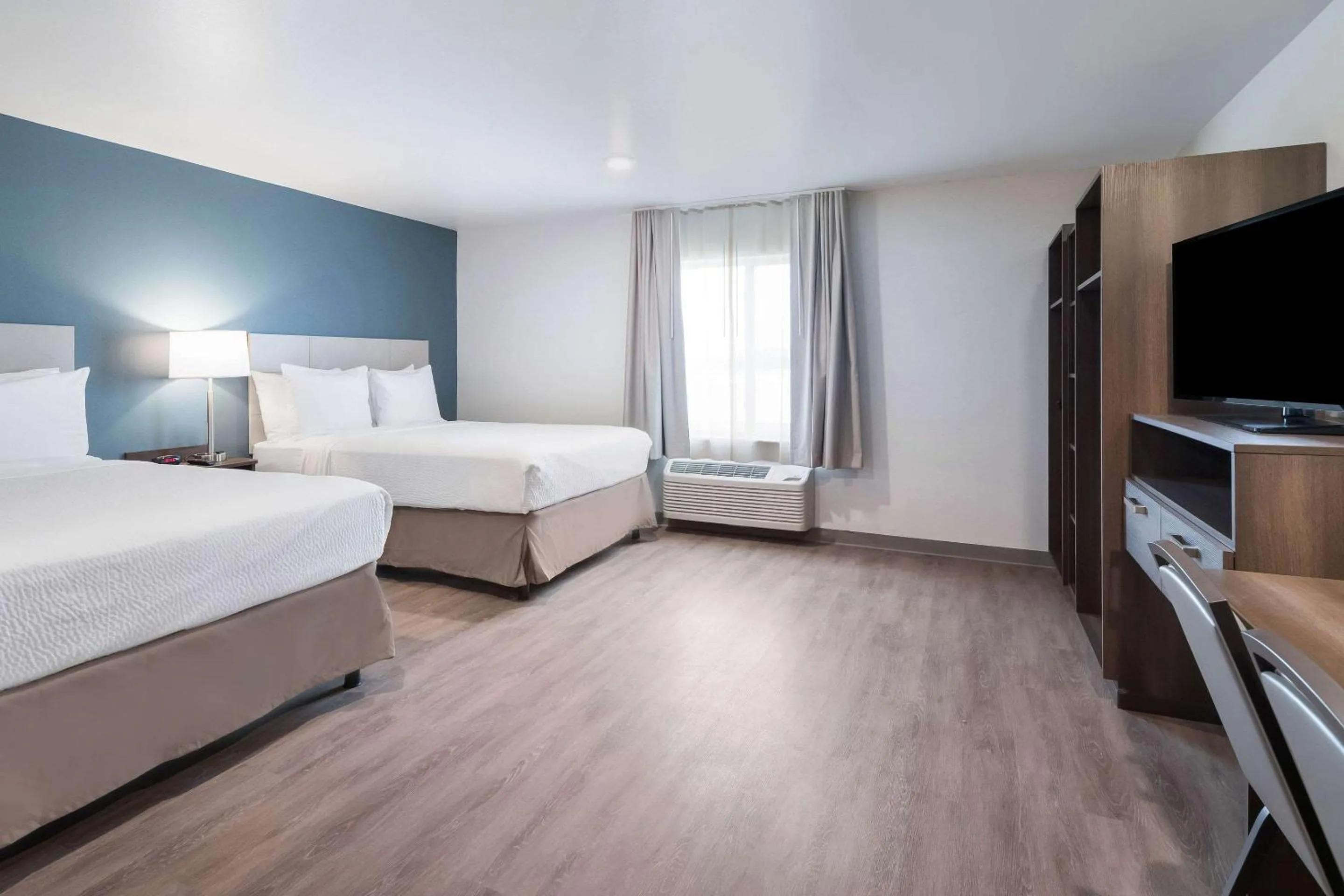 Photo of the whole room, Bed in WoodSpring Suites Dallas Plano Central Legacy Drive