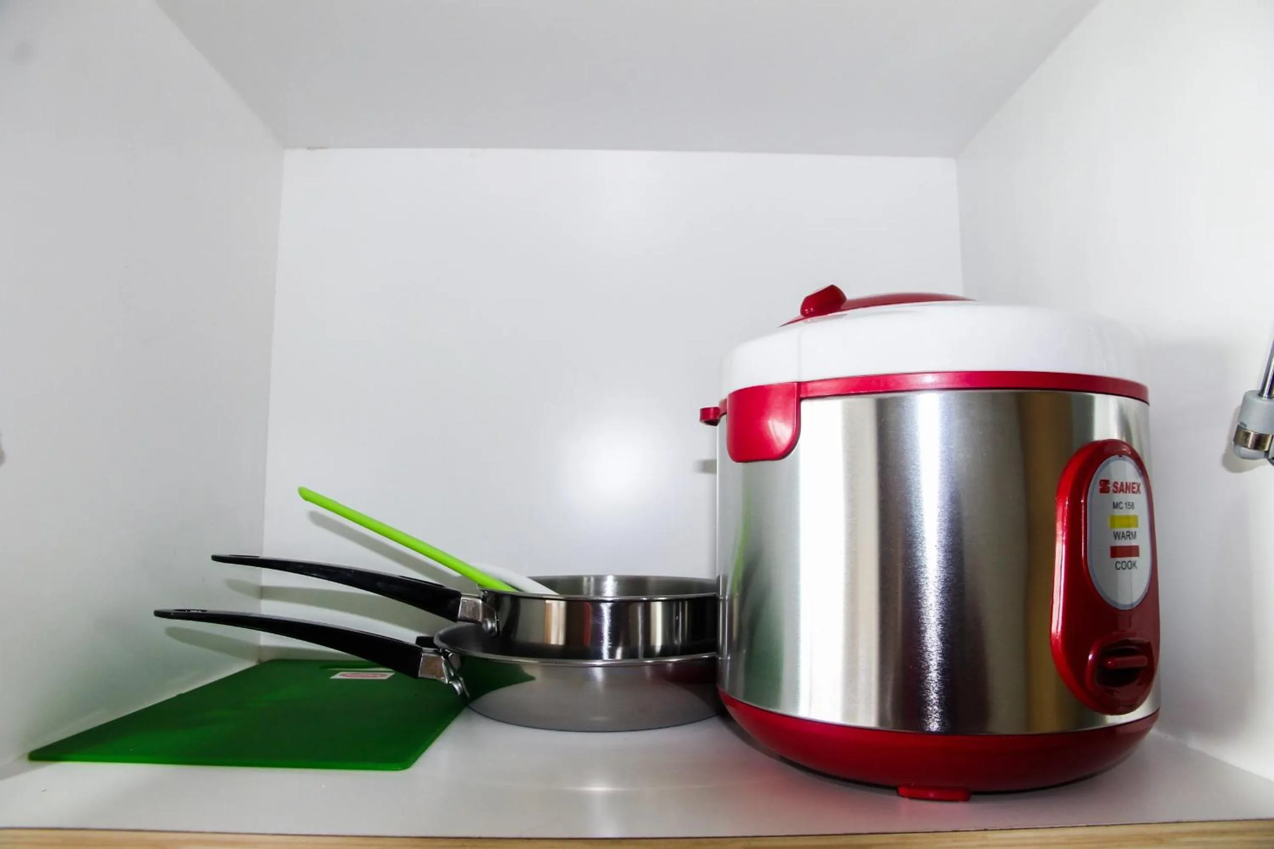 Kitchen or kitchenette in Modern and Cozy Studio Room The Oasis Cikarang Apartment By Travelio