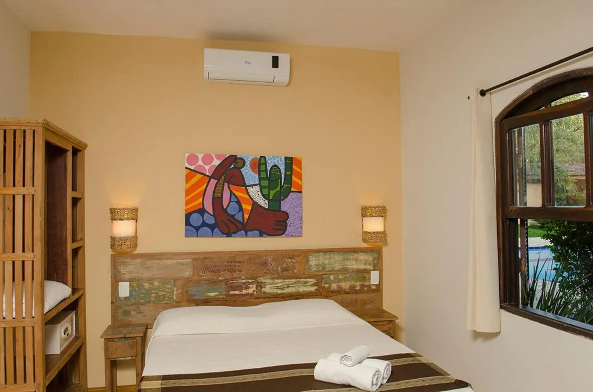 Bed in Pousada Tupinamba