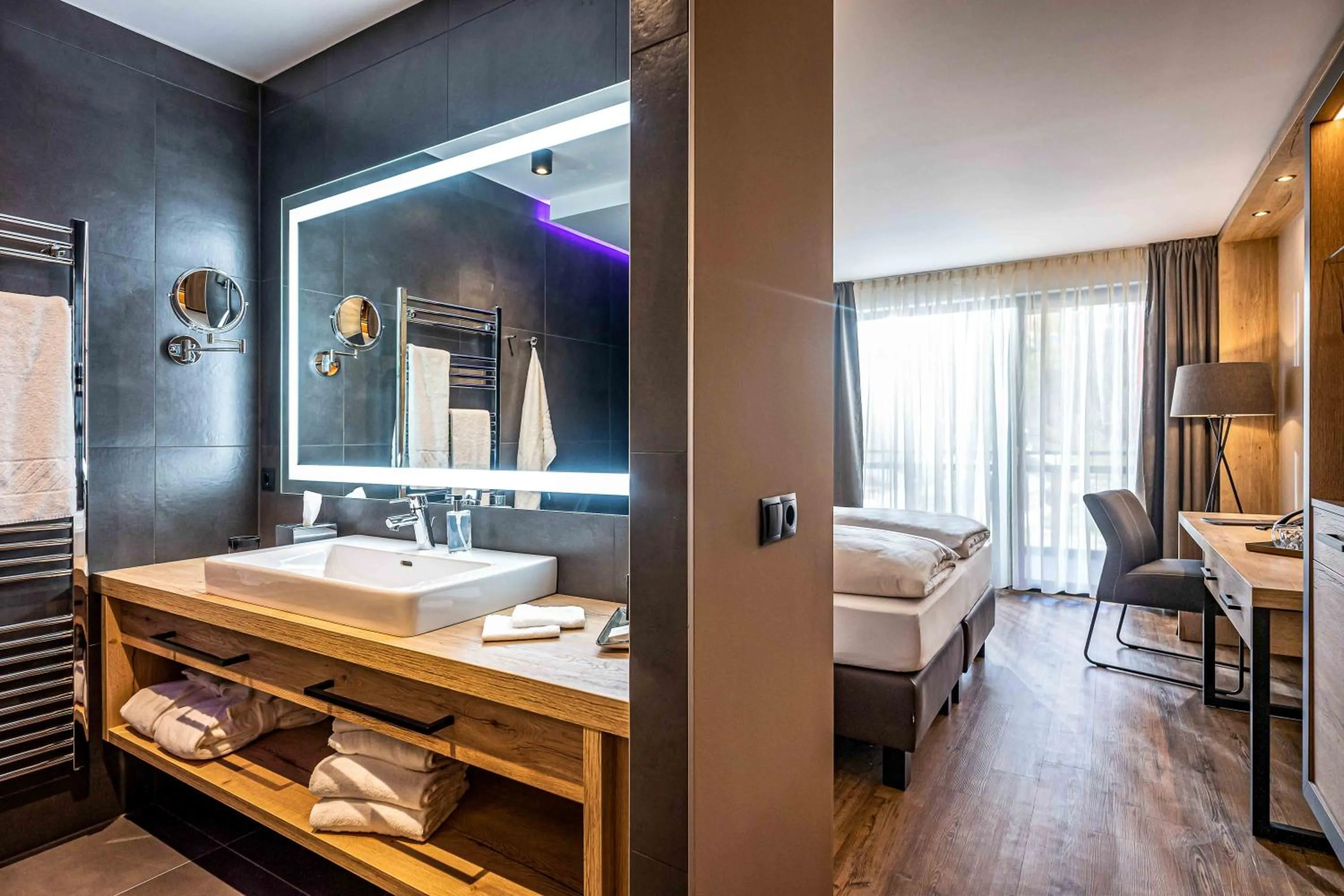 Bathroom, Bed in Hotel Adapura Wagrain