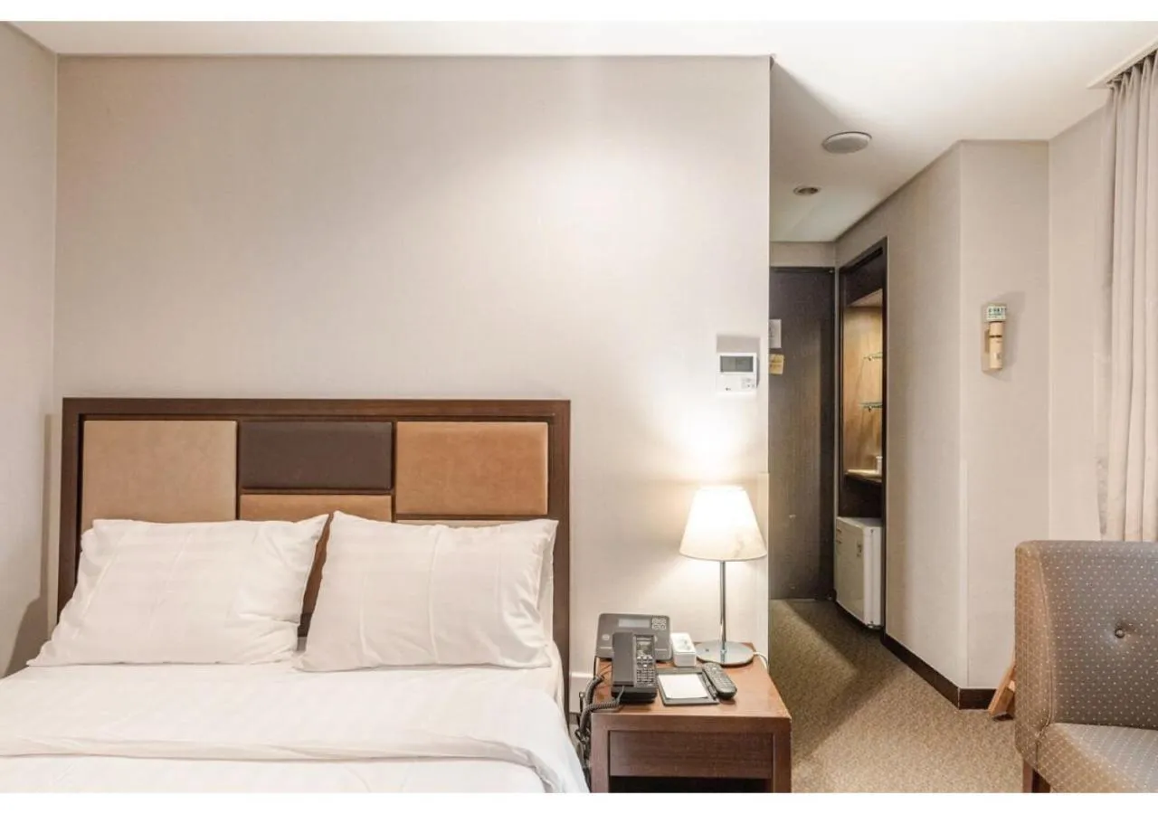 Bed in New Seoul Hotel Myeongdong