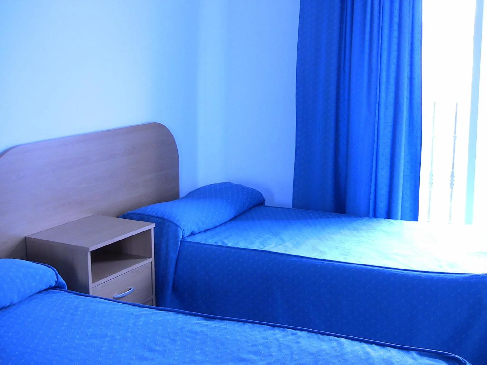 Bed in Apartahotel Los Hermanos