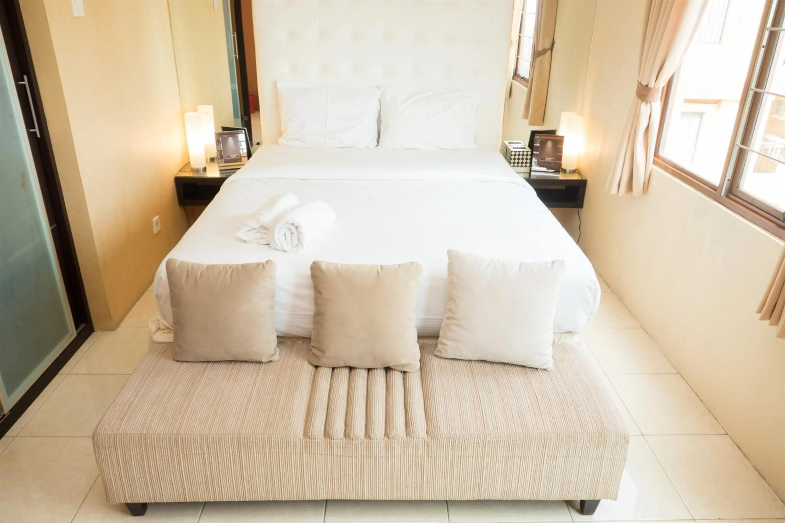 Bed in Antique 3BR at Grand Setiabudi Apartment By Travelio