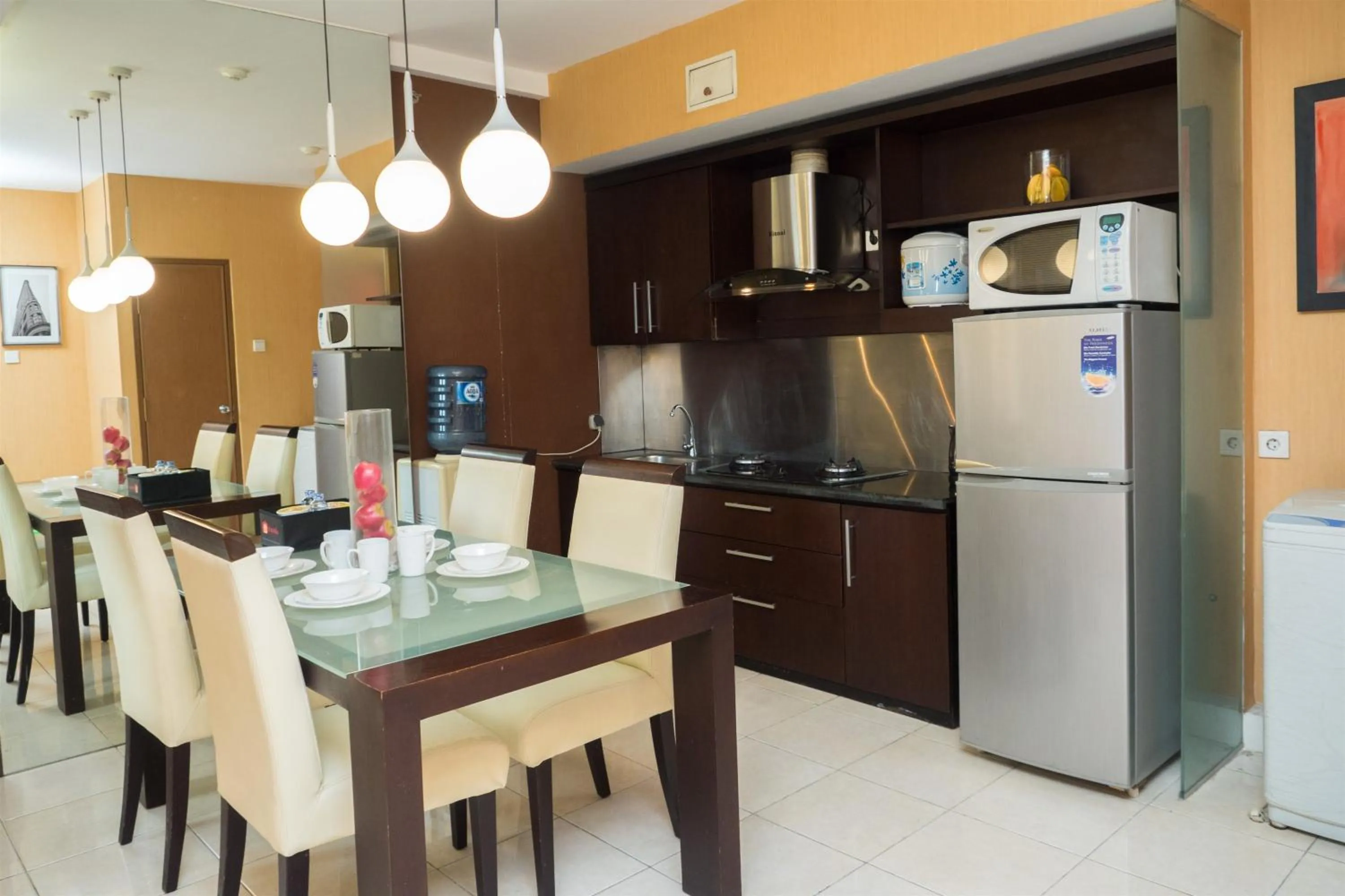 Kitchen or kitchenette in Antique 3BR at Grand Setiabudi Apartment By Travelio