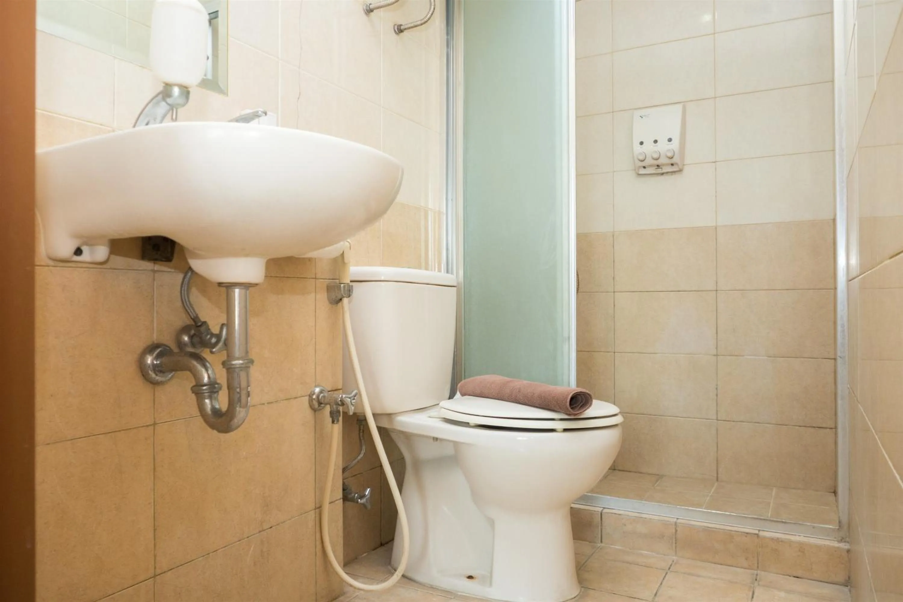 Bathroom in Antique 3BR at Grand Setiabudi Apartment By Travelio