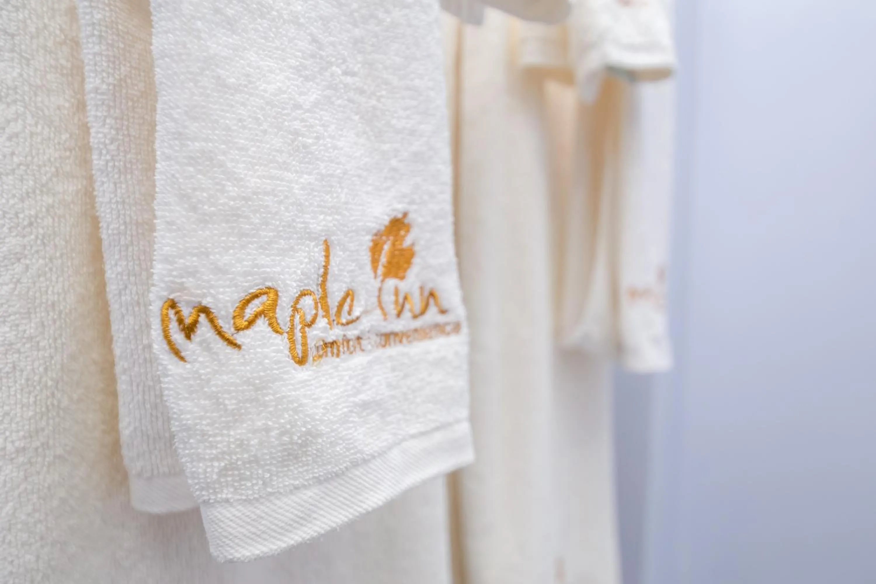 Property logo or sign in Maple Inn Hotel