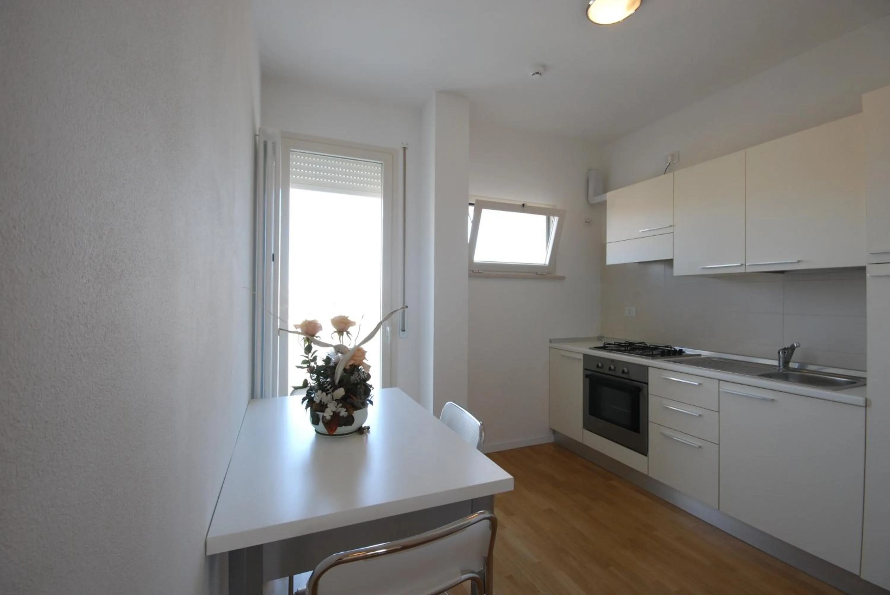 Kitchen or kitchenette in Amadei Hotel Figaro & Apartments