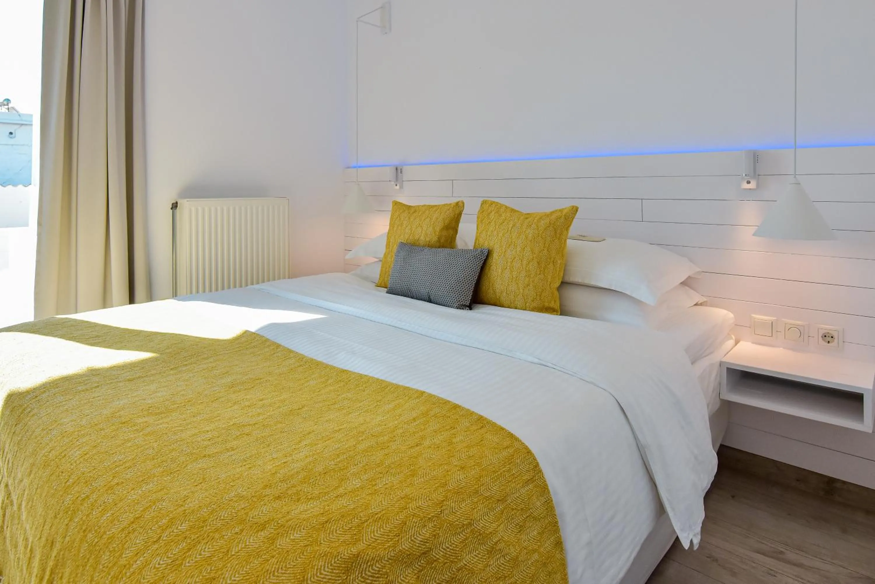 Bed in White Rock Milos Suites