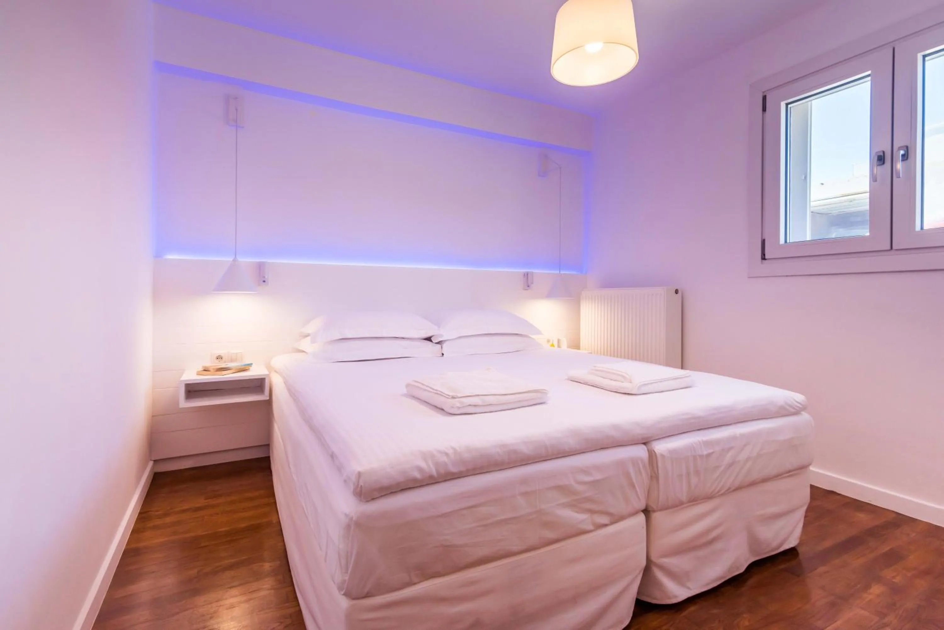 Bed in White Rock Milos Suites