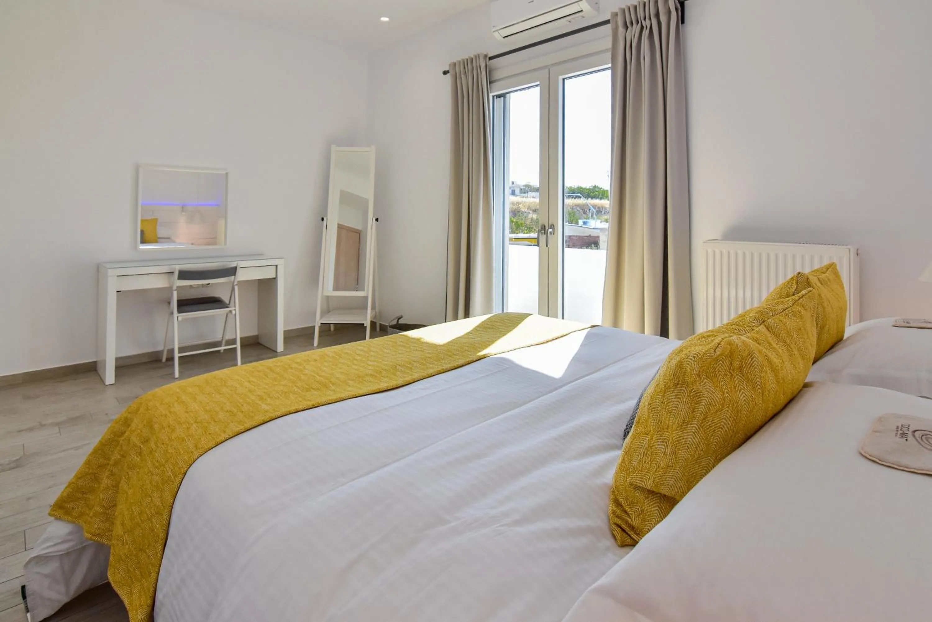 Bed in White Rock Milos Suites