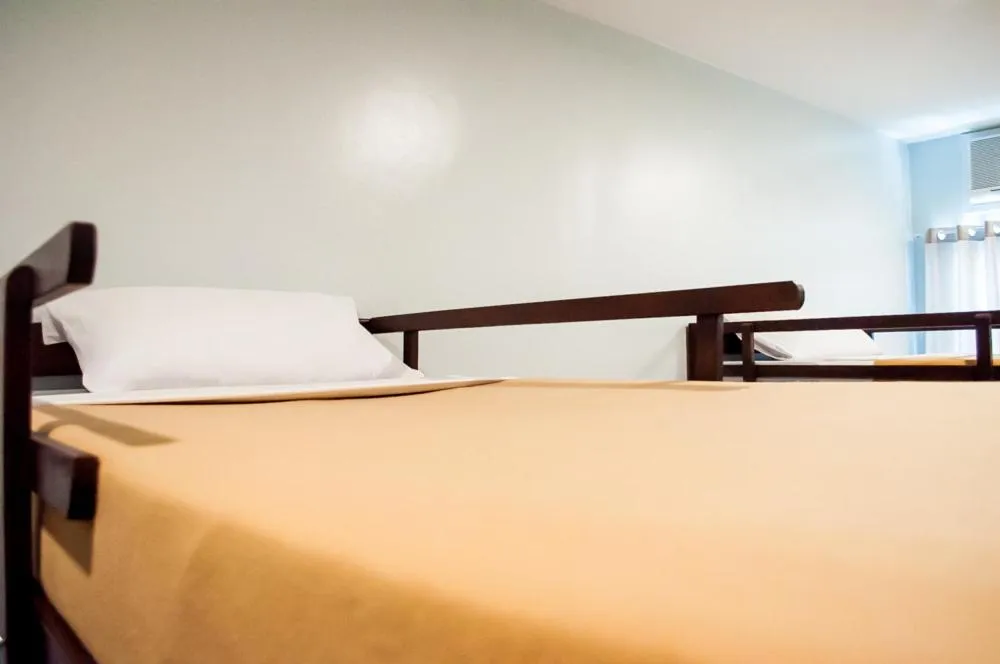 Bed in Seasons Hotel Sablayan