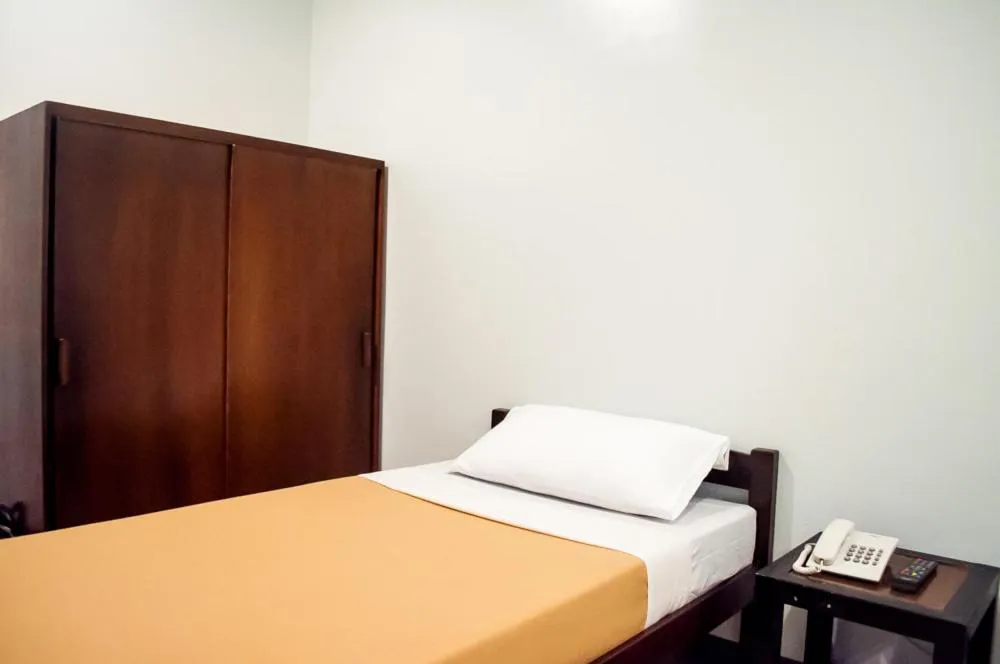 Bed in Seasons Hotel Sablayan