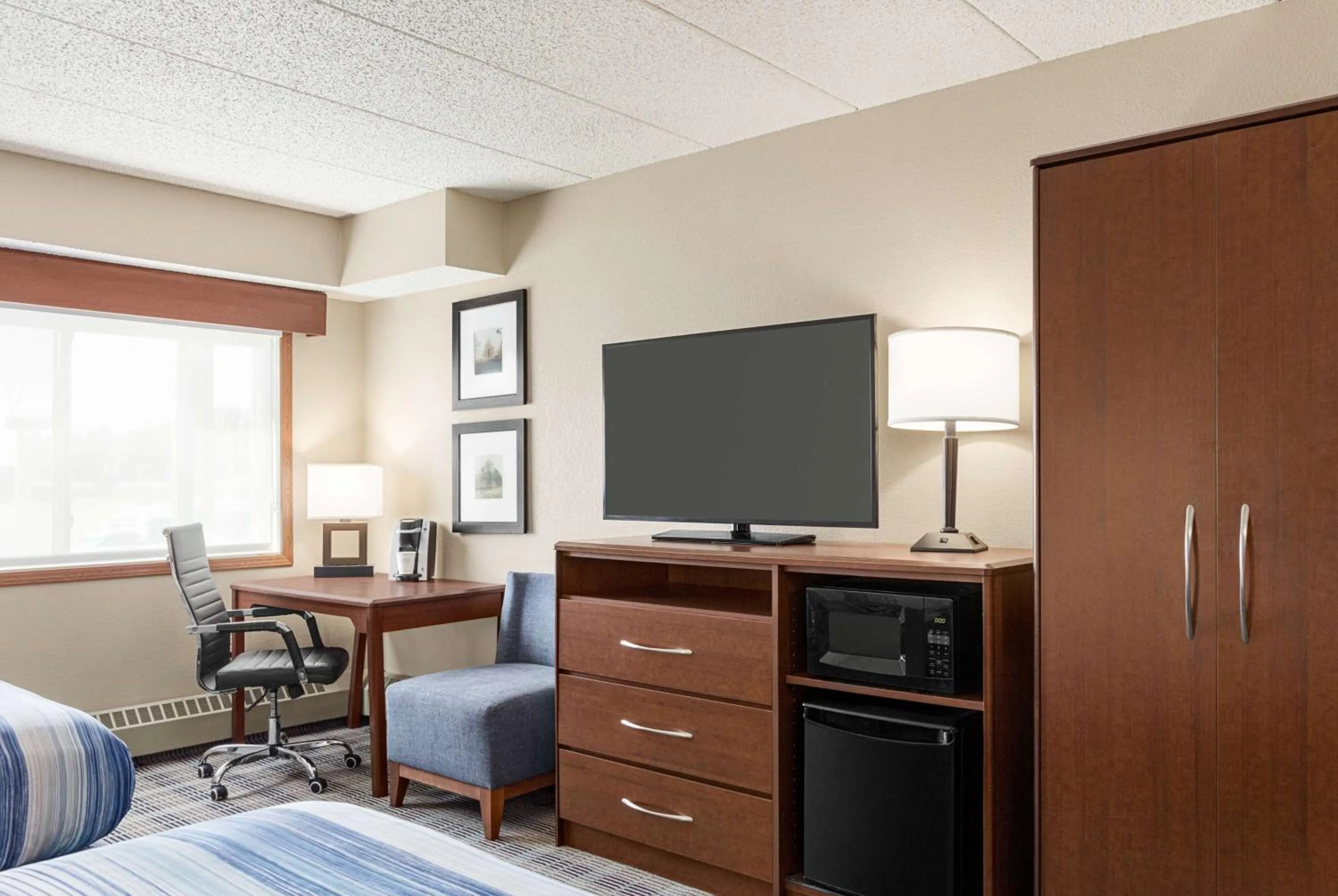 Bed in AmericInn by Wyndham Roseau