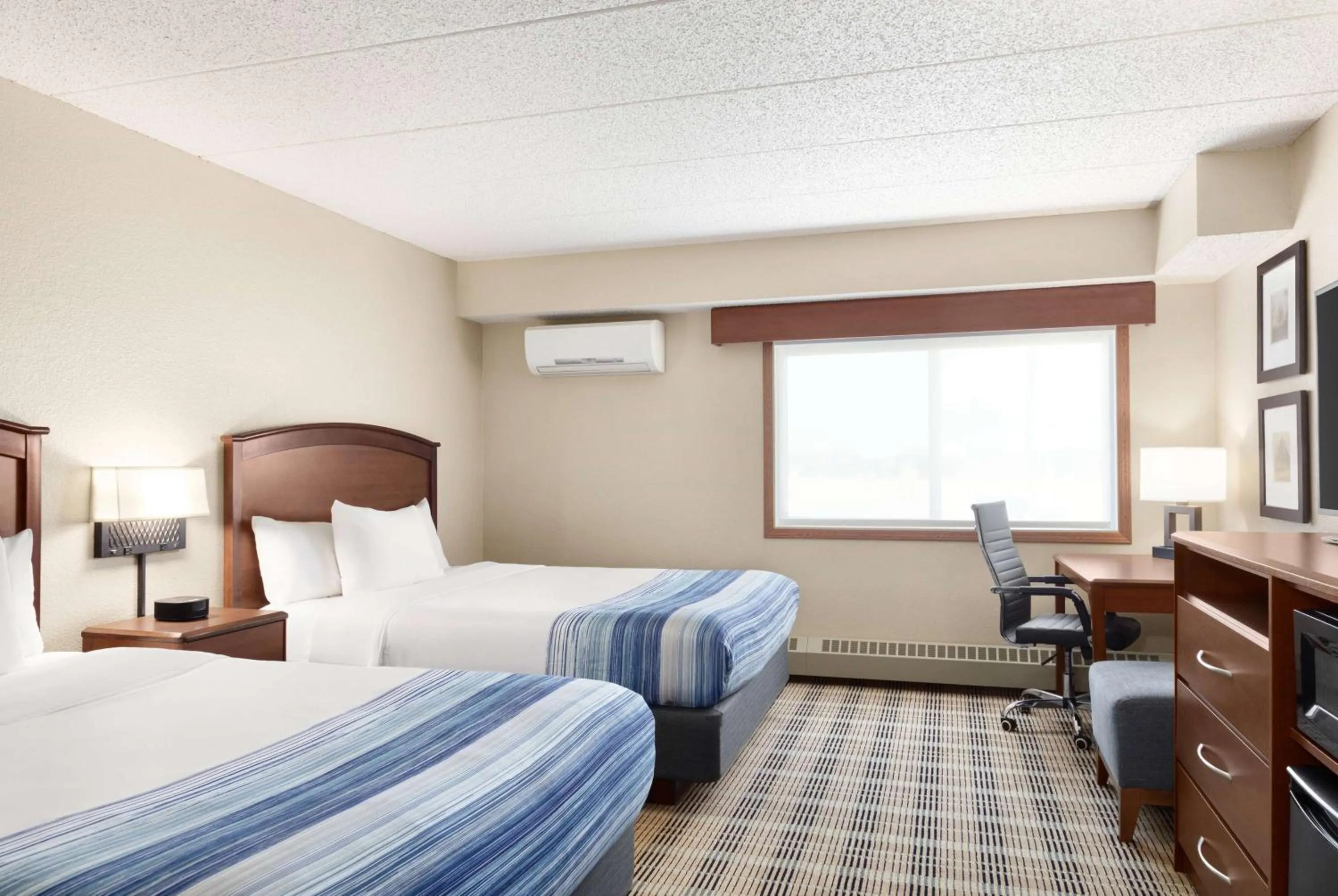 Bed in AmericInn by Wyndham Roseau