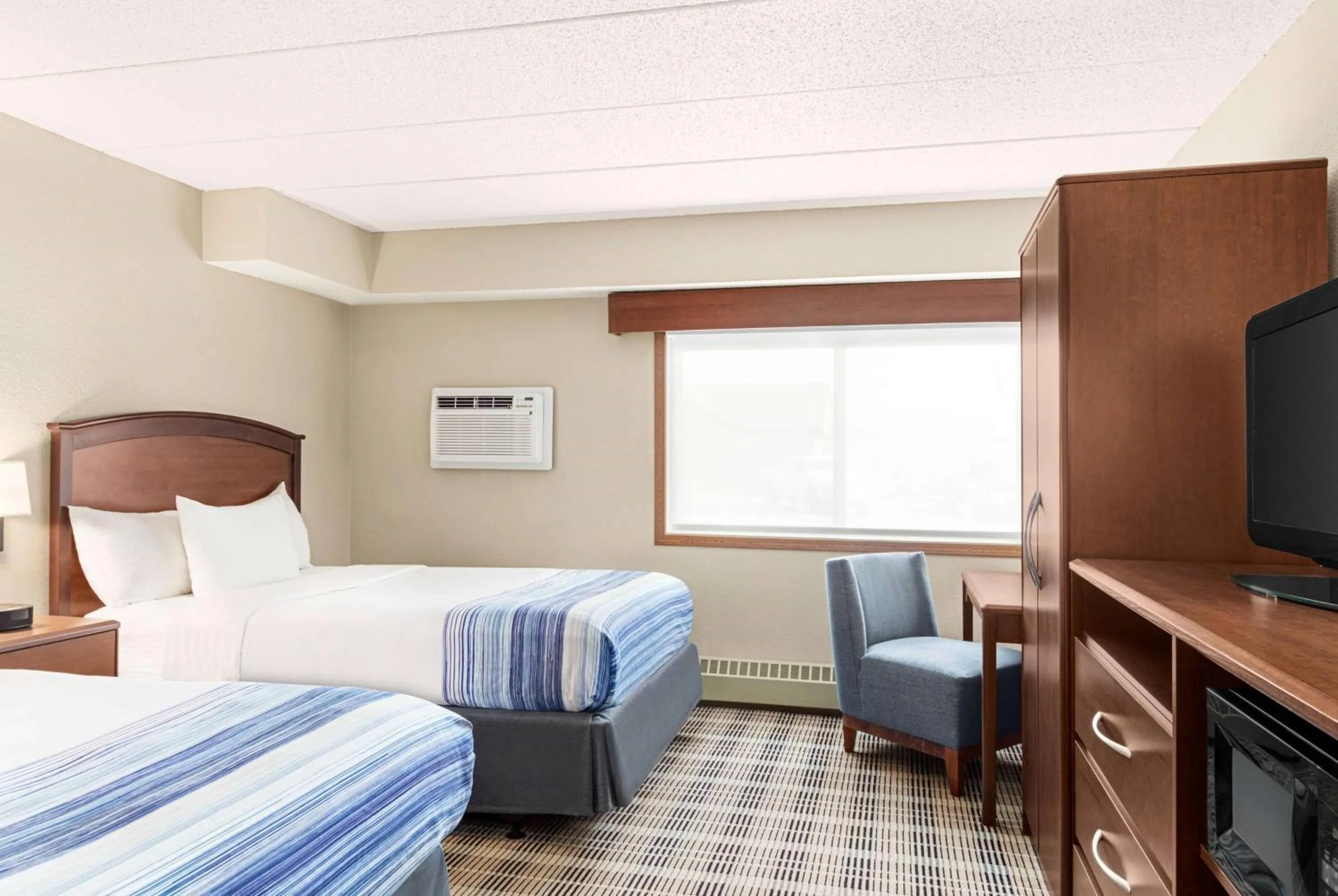 Bed in AmericInn by Wyndham Roseau
