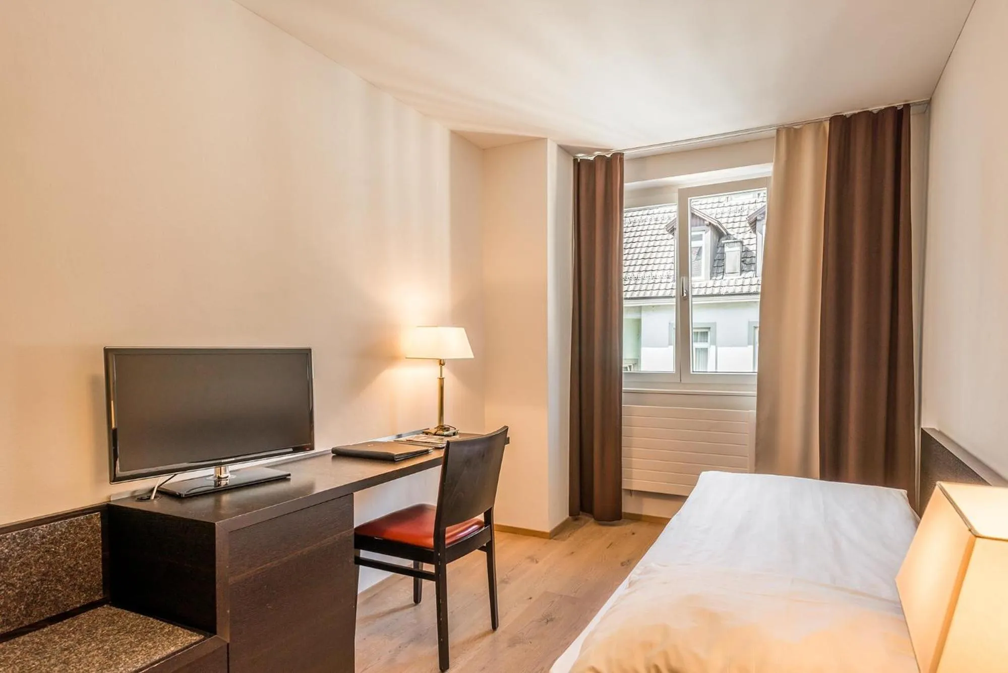 Photo of the whole room, Bed in Hotel Alpina Luzern