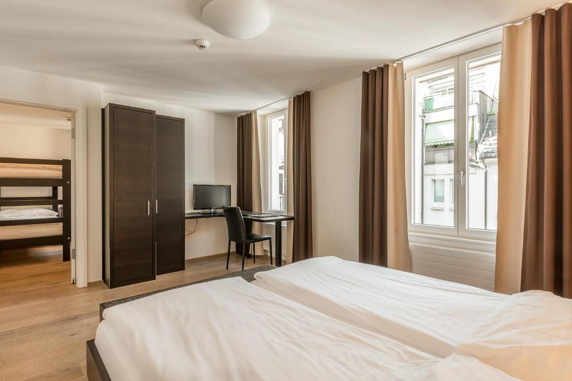 Photo of the whole room, Bed in Hotel Alpina Luzern