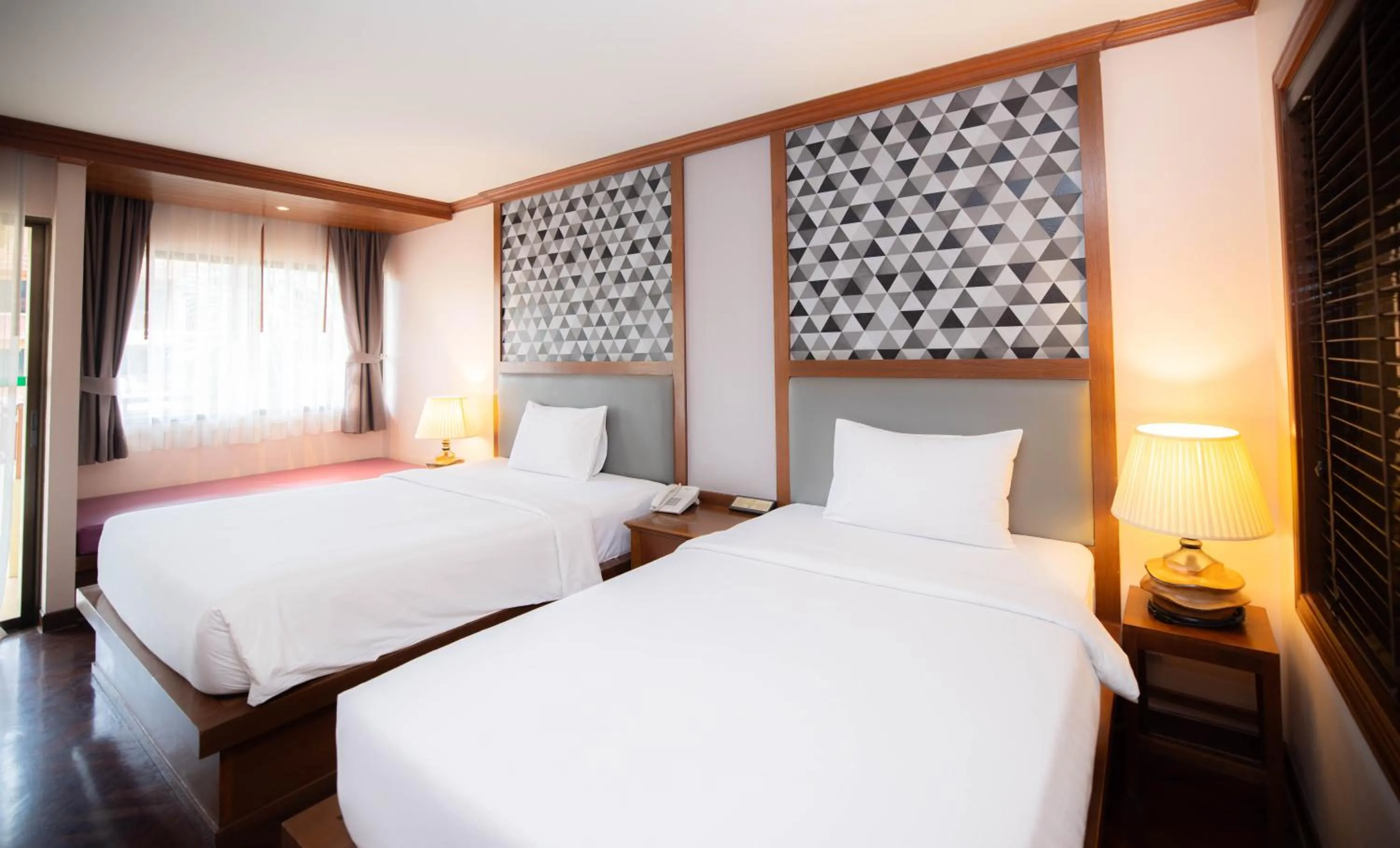 Bed in Baumanburi Hotel Patong