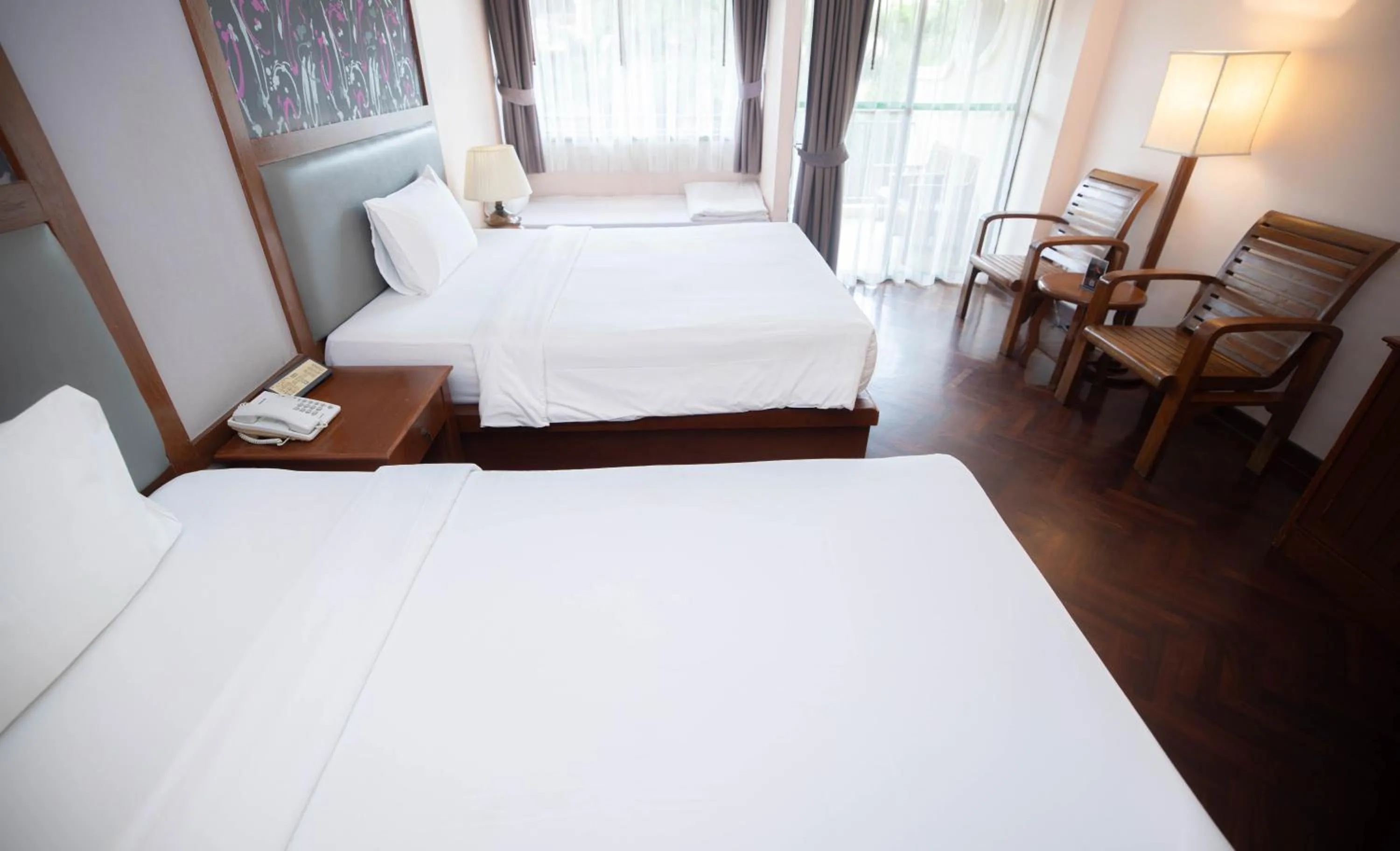 Bed in Baumanburi Hotel Patong