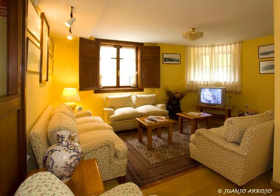 Communal lounge/ TV room in La Casona de Mestas