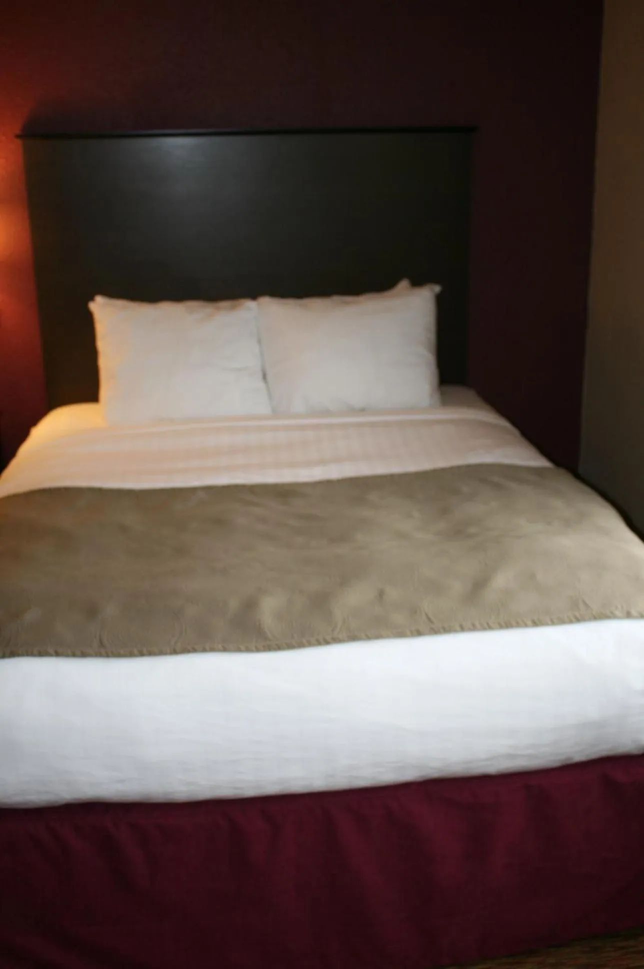 Bed in AmericInn by Wyndham Osceola
