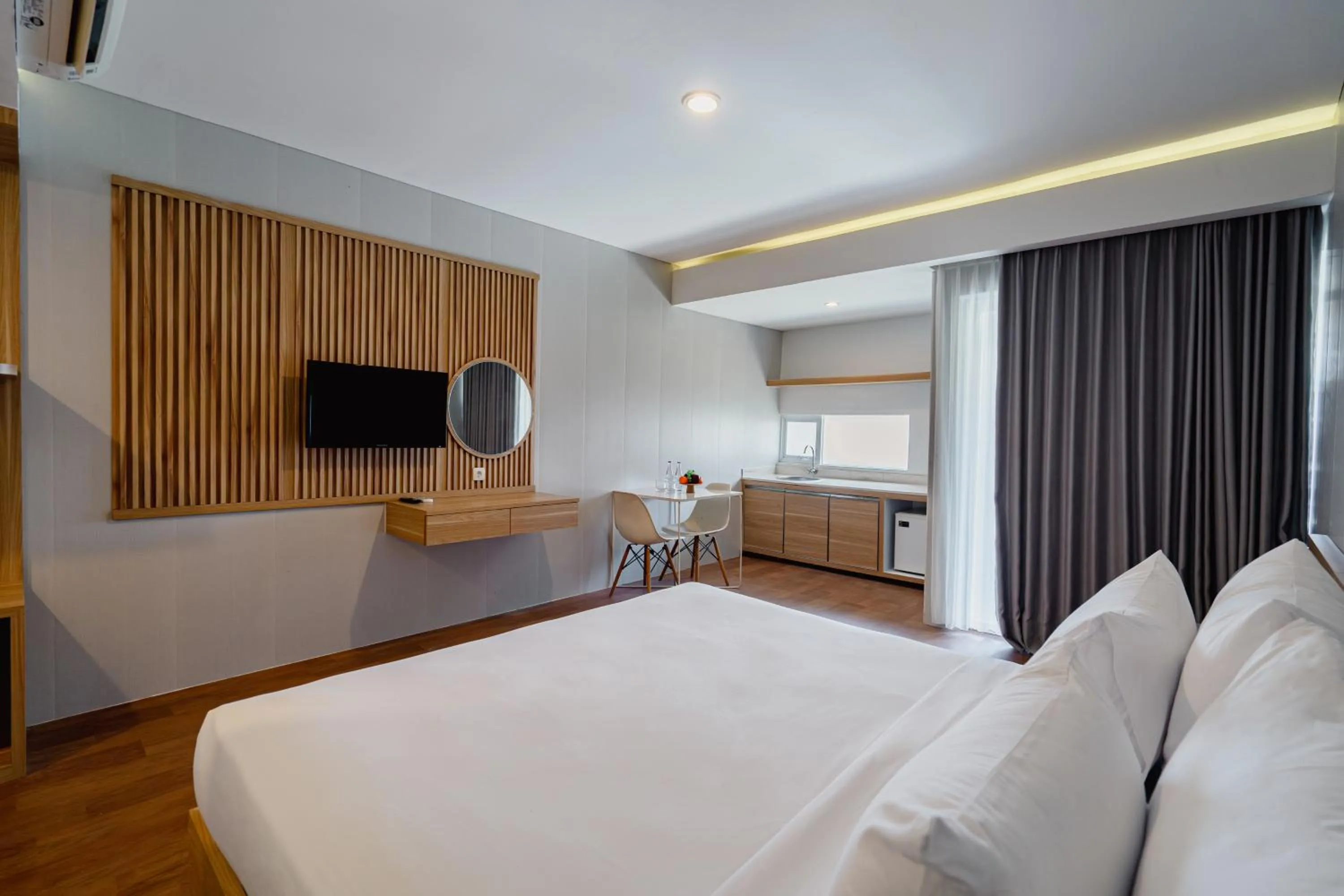 Bed in The Rooms Apartment Bali by ARM Hospitality
