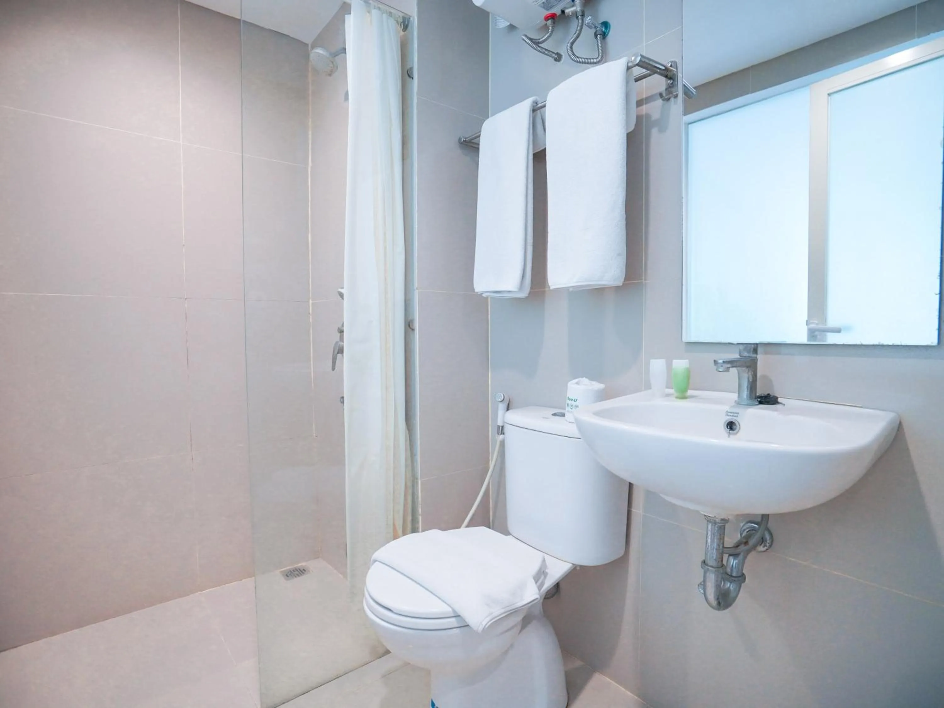 Shower in The Rooms Apartment Bali by ARM Hospitality