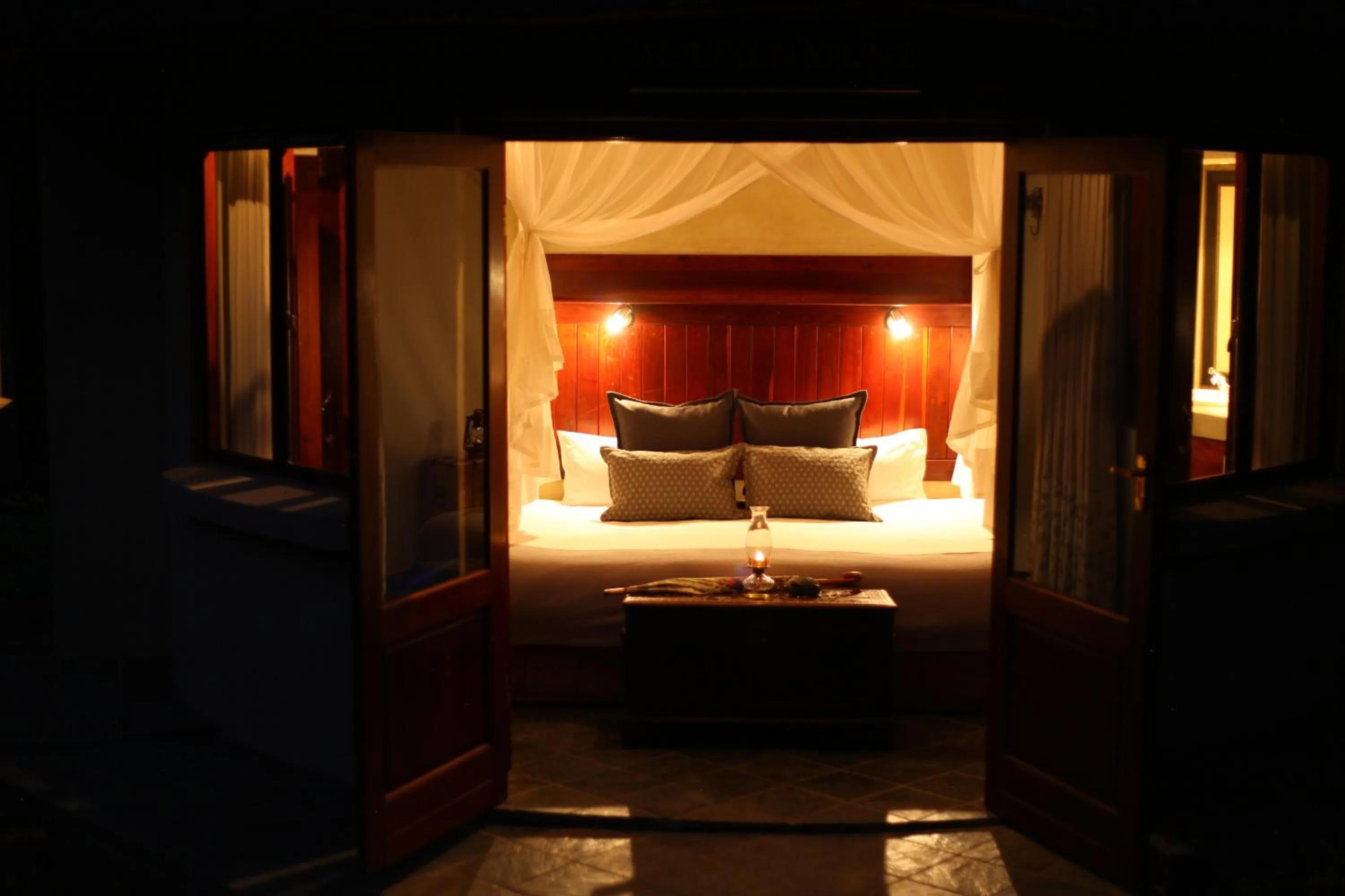 Bed in Ivory Wilderness River Rock Lodge