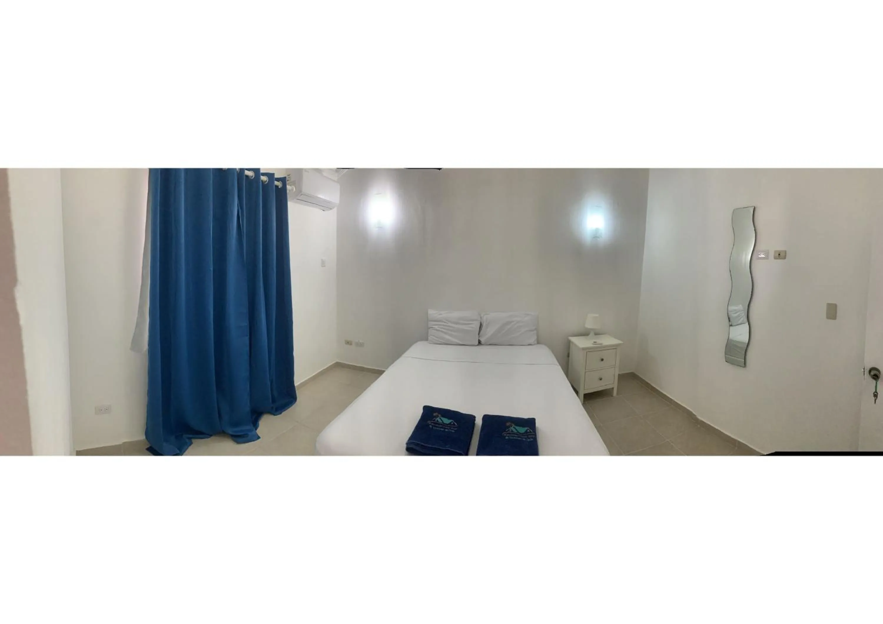 Bed in Karimar Beach Condo Hotel