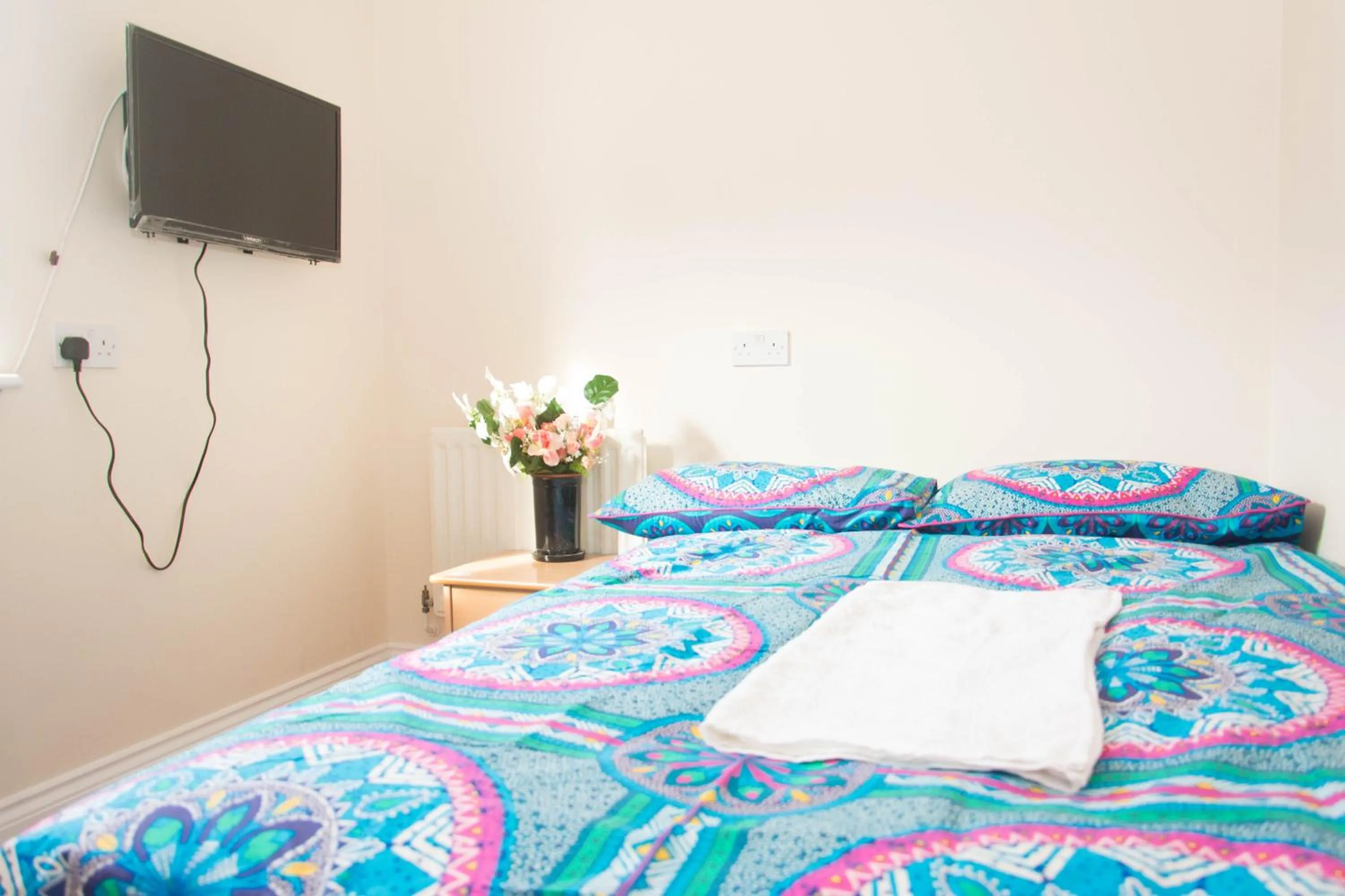 Bed in QUEEN GUEST HOUSE