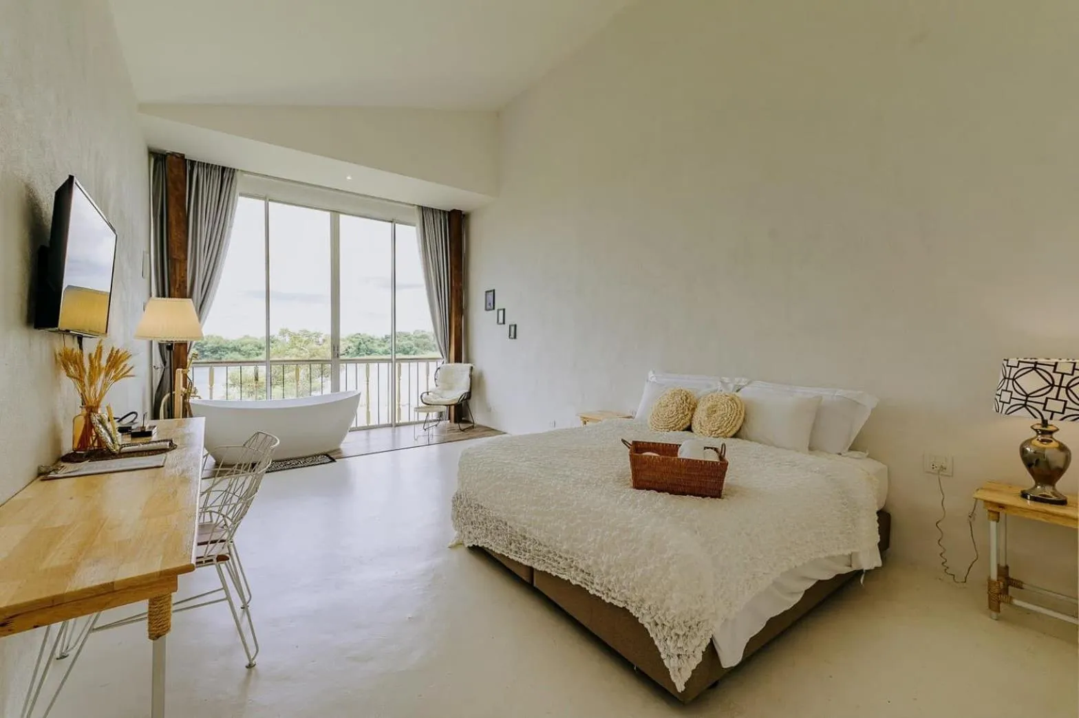 Bed in White Wall Riverfront Hotel