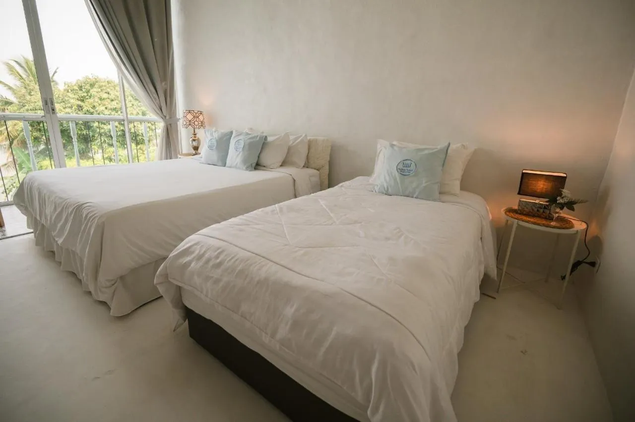 Bed in White Wall Riverfront Hotel