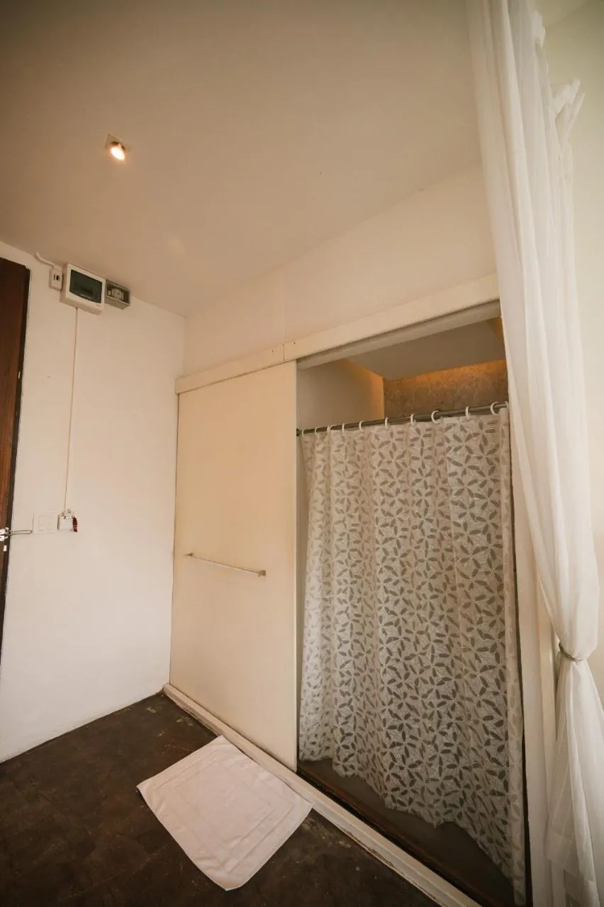 Bed in White Wall Riverfront Hotel