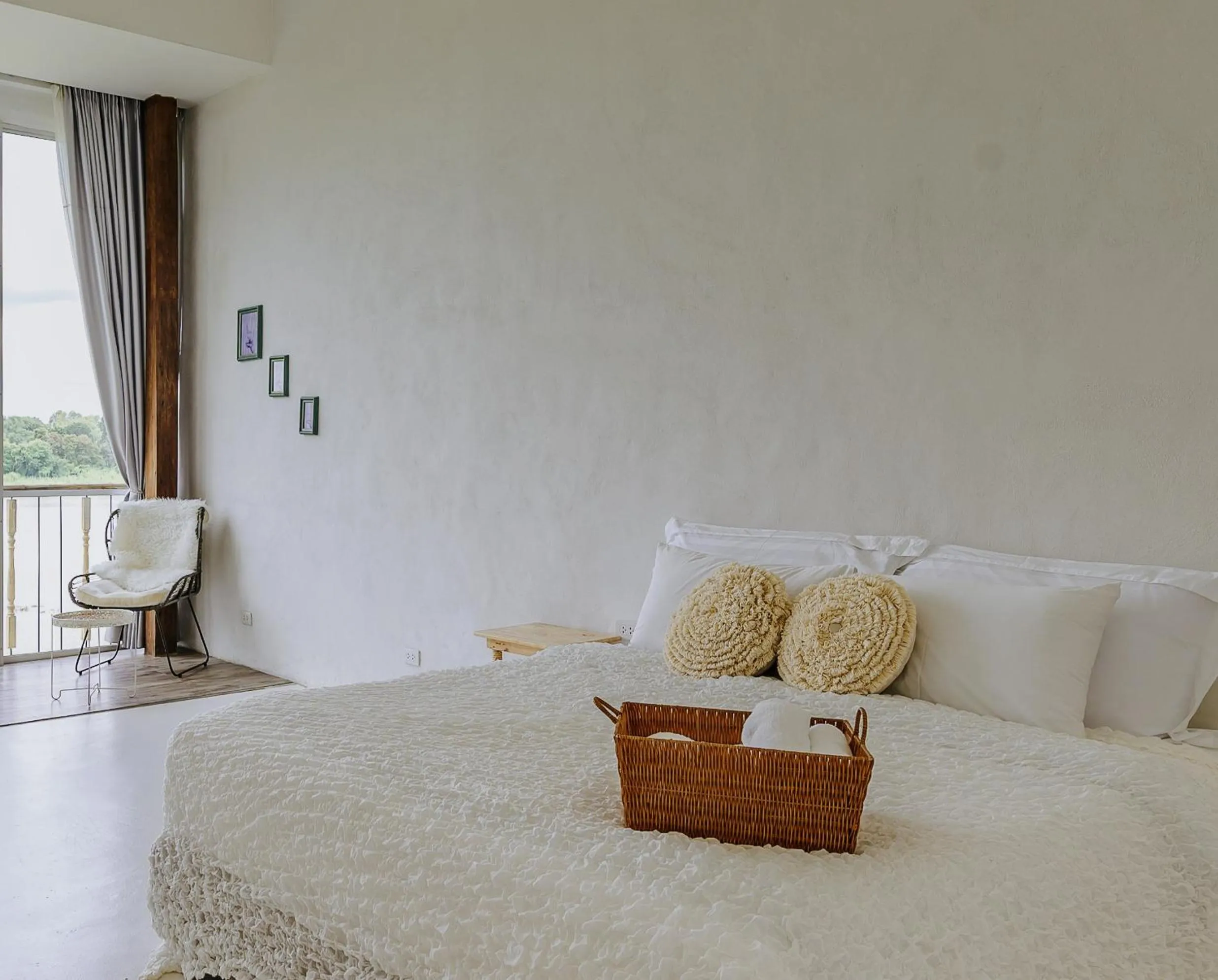 Bed in White Wall Riverfront Hotel