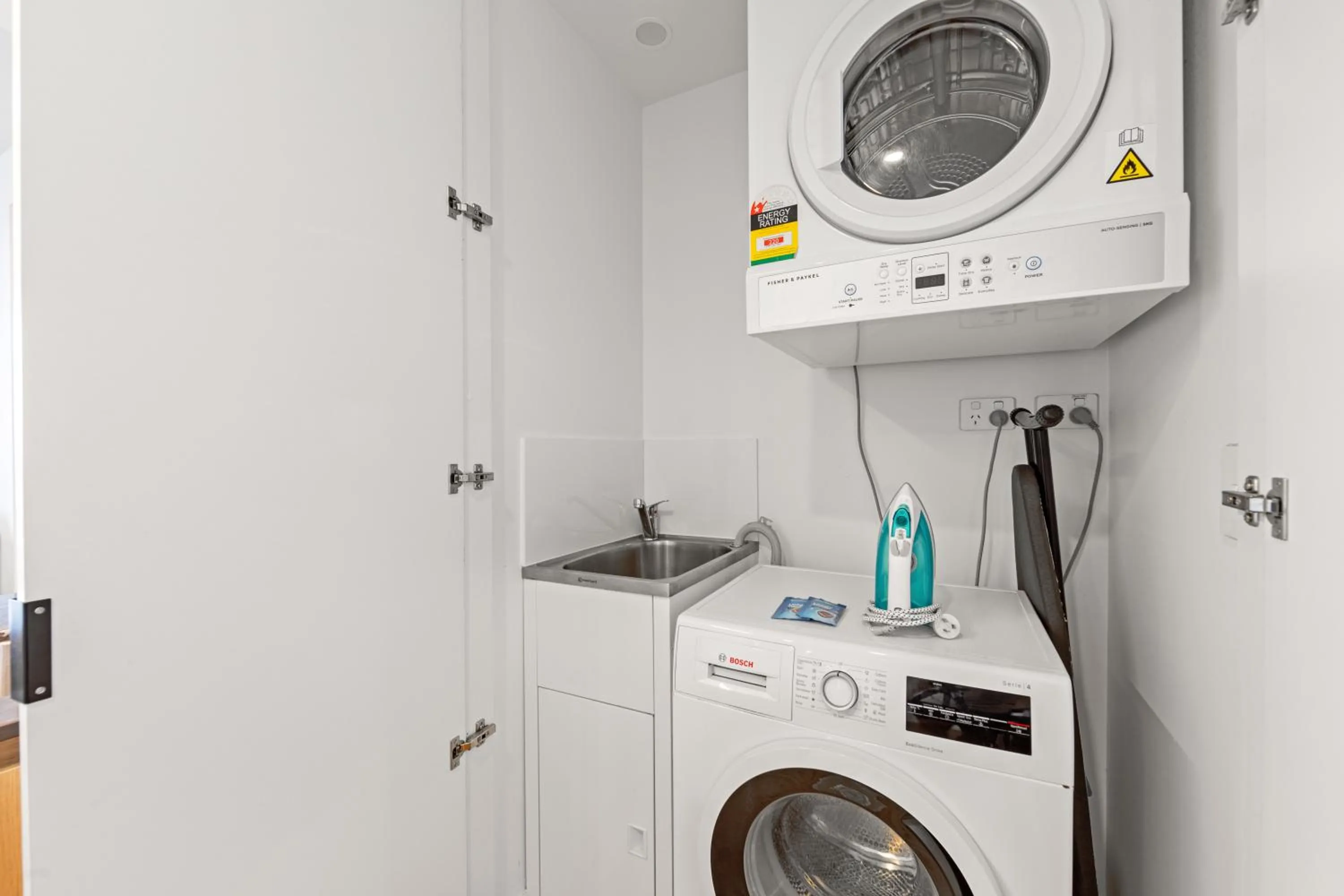 washing machine in Brisbane One Apartments by CLLIX