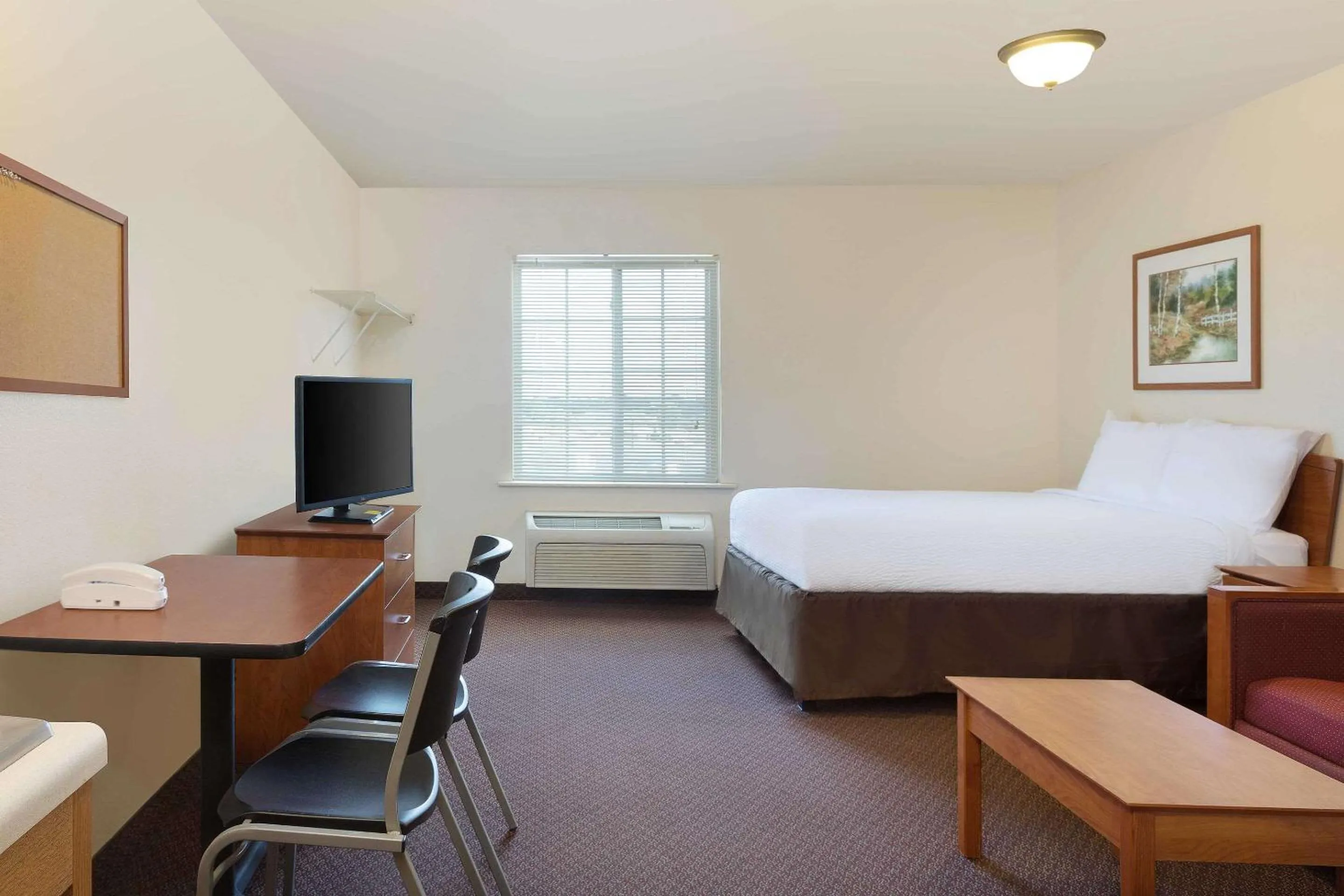 Photo of the whole room, Bed in WoodSpring Suites Tyler Rose Garden