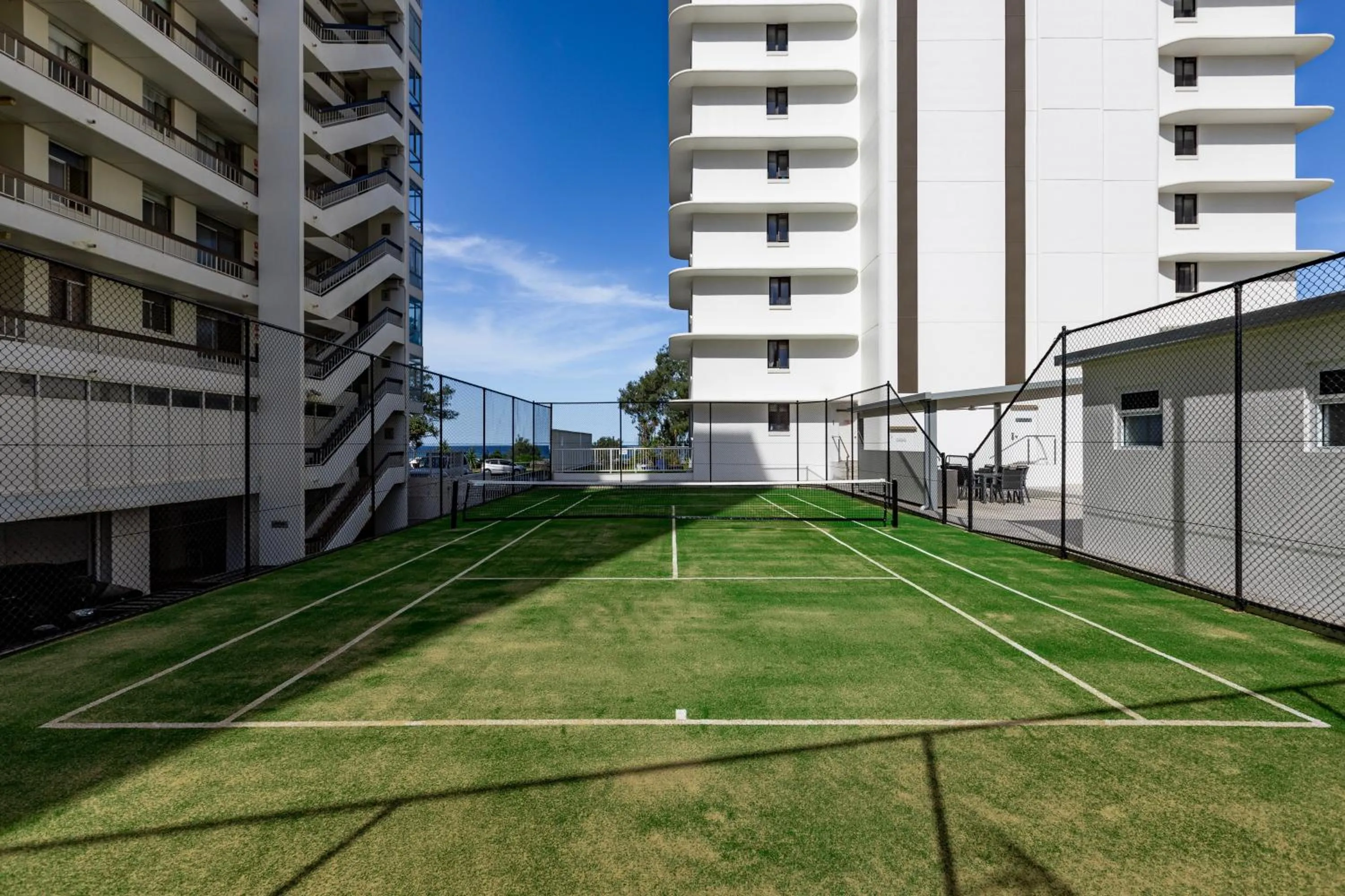 Tennis court in Olympus Beachfront Apartments