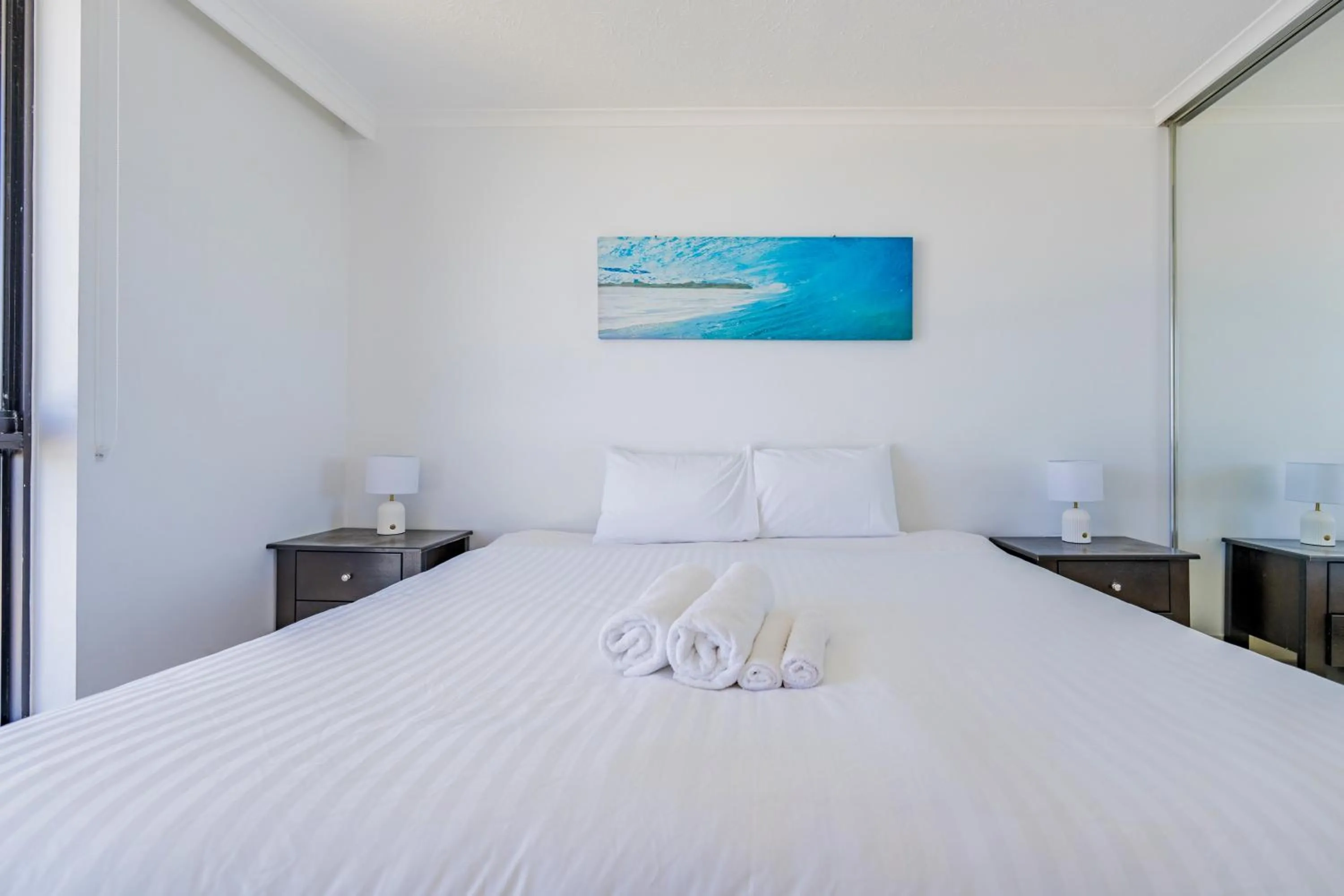 Bed in Olympus Beachfront Apartments