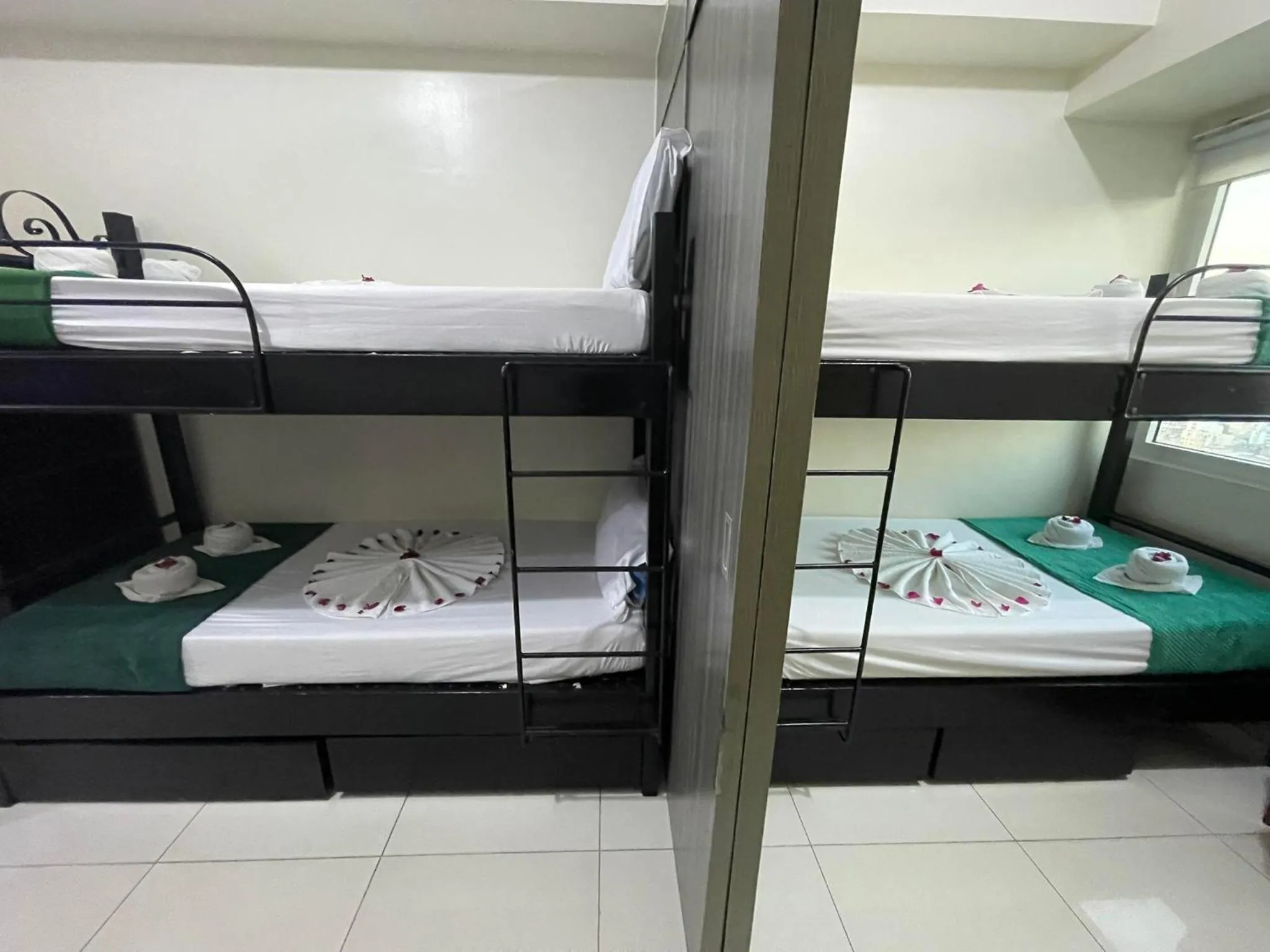 Bed in Green Residences Stays by PBYY