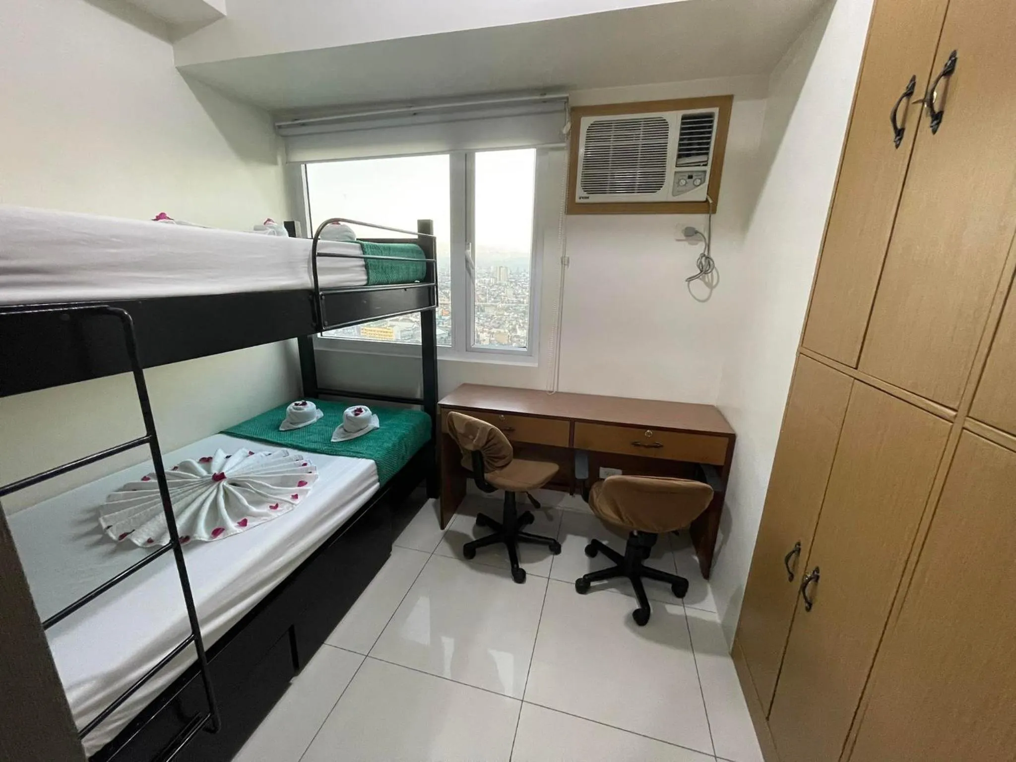 Bed in Green Residences Stays by PBYY