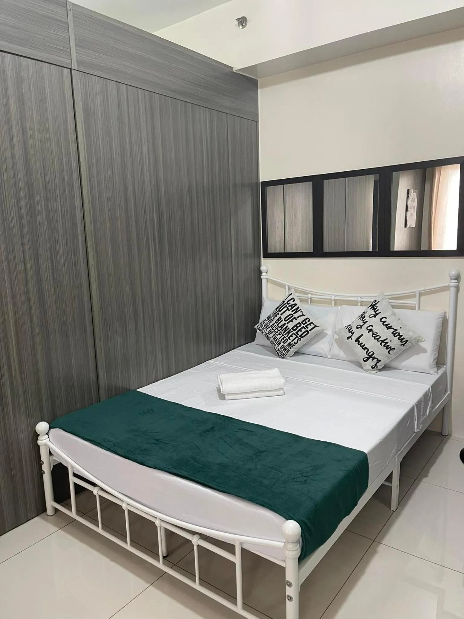 Bed in Green Residences Stays by PBYY