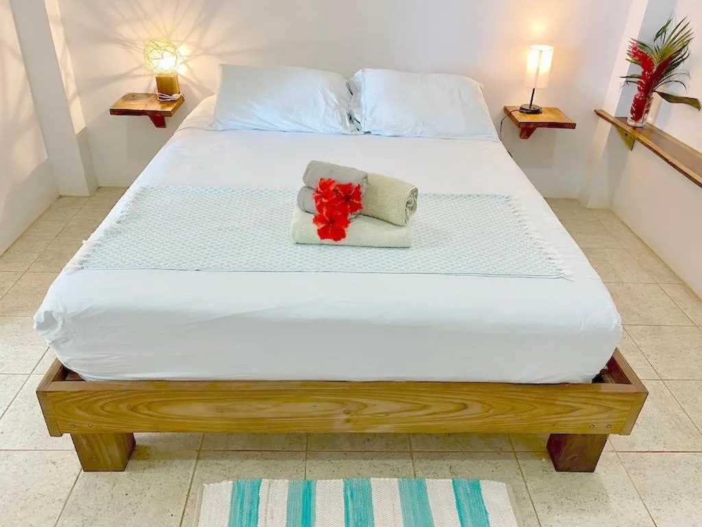 Bed in Bird Island Bungalows