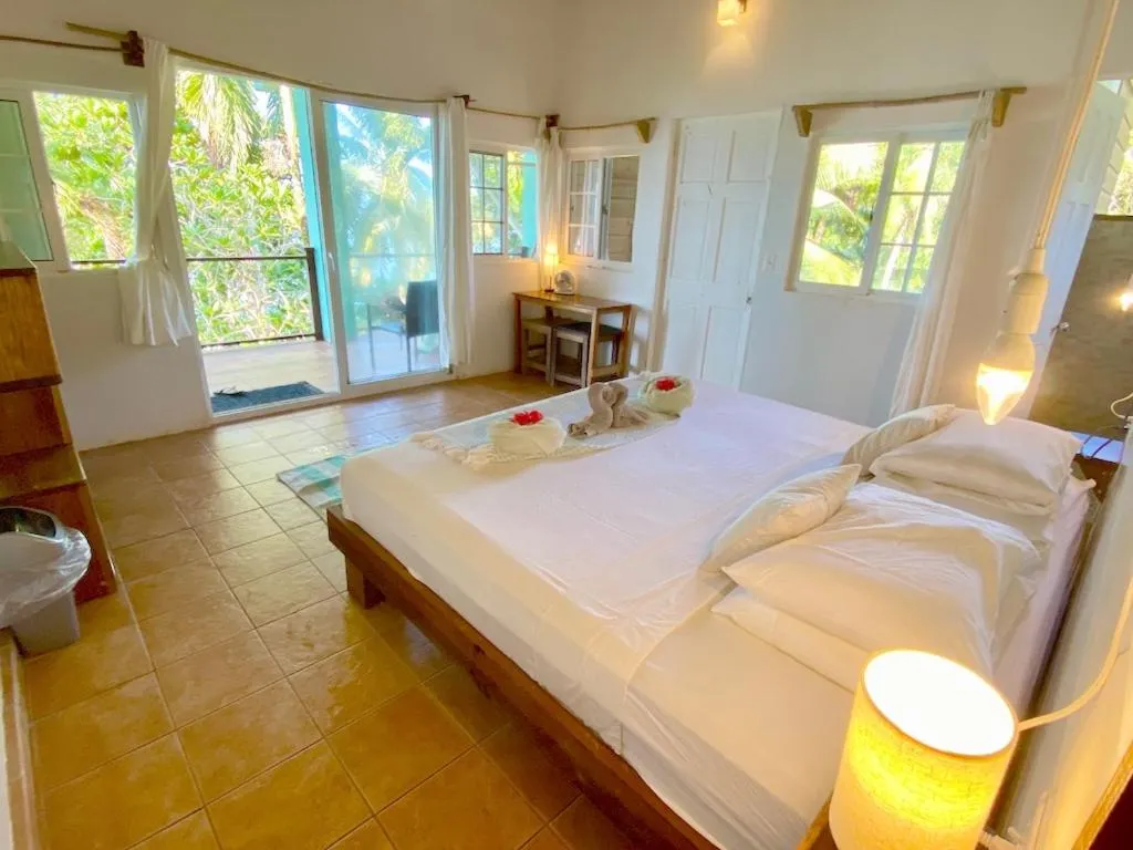 Bed in Bird Island Bungalows