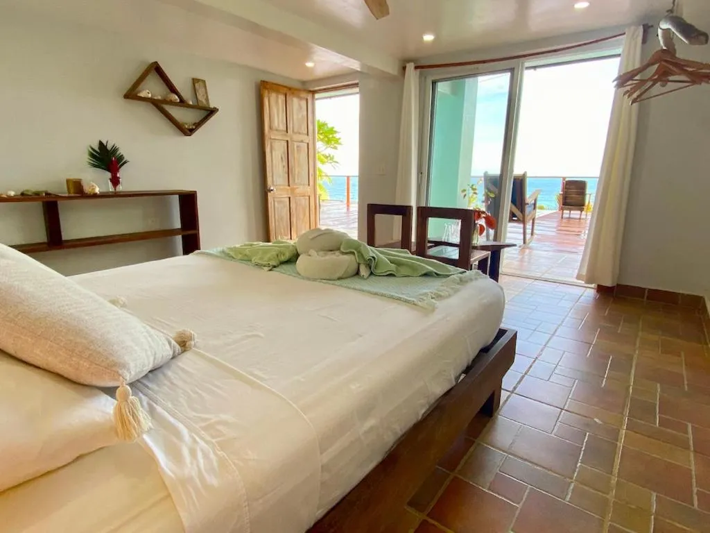 Bed in Bird Island Bungalows