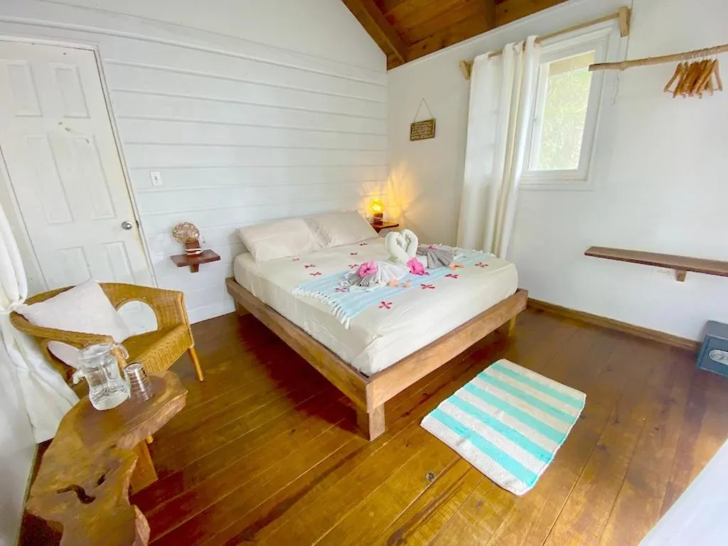 Bed in Bird Island Bungalows