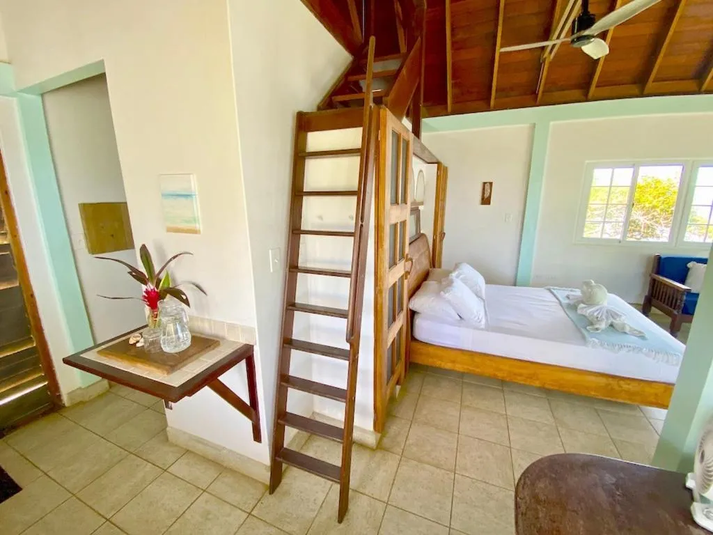 Bed in Bird Island Bungalows