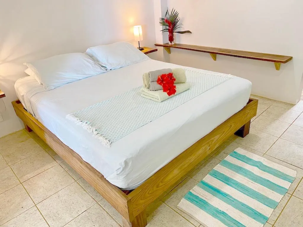 Bed in Bird Island Bungalows