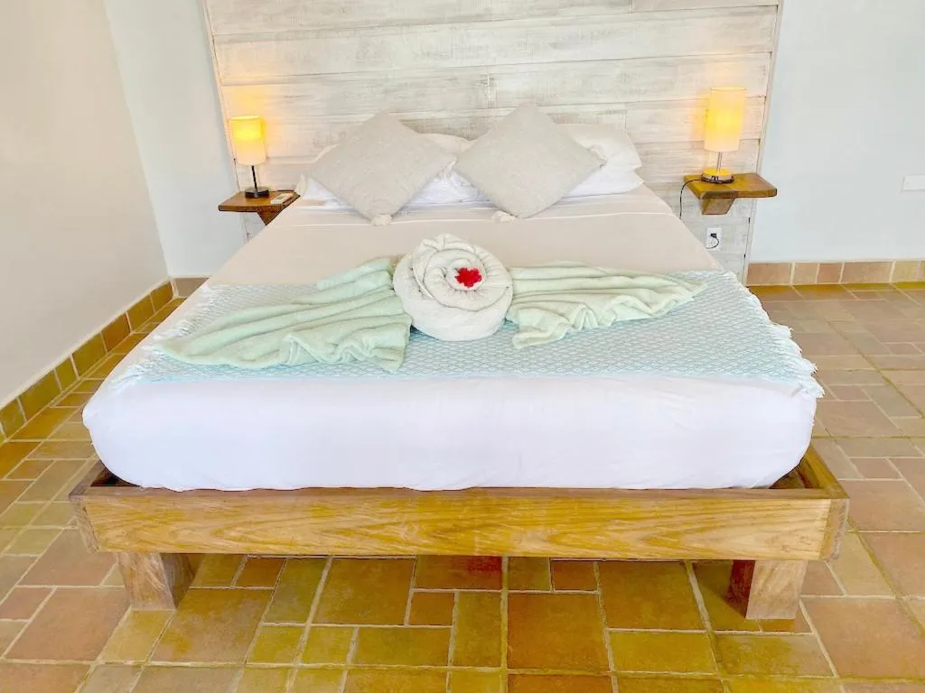 Bed in Bird Island Bungalows