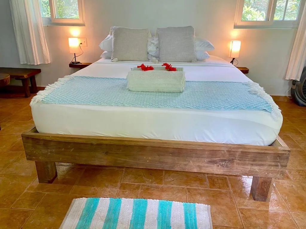 Bed in Bird Island Bungalows